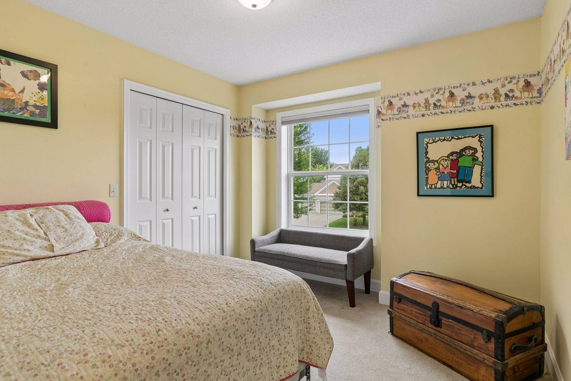 957 Lake Ridge Bay, Woodbury, MN 55129 The first of three upper level bedrooms provides a generous layout with carpet flooring, an oversized window, walk in closet, and overhead lighting.