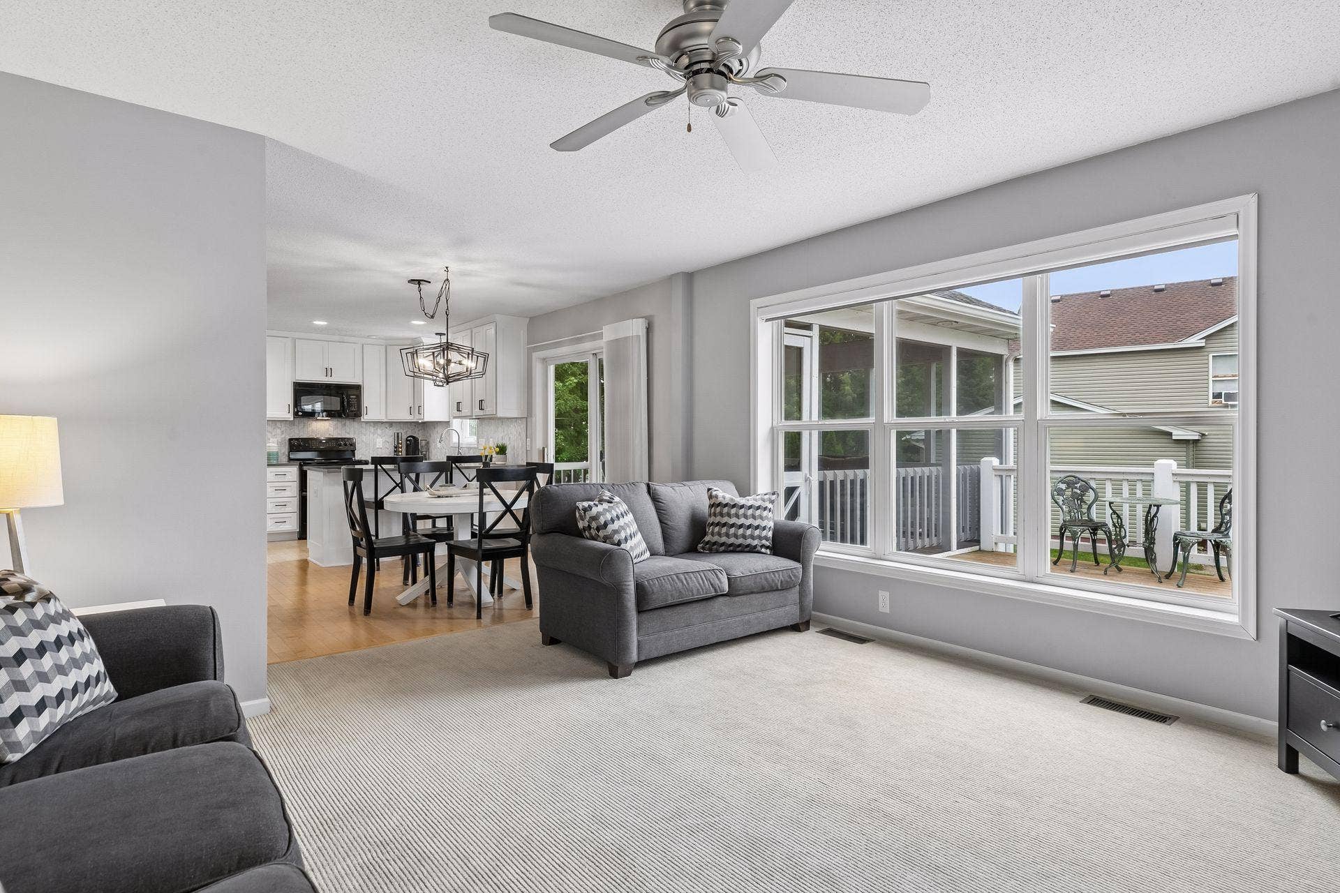 957 Lake Ridge Bay, Woodbury, MN 55129 A wall of three oversized windows brightens the family room, with a view looking back to the informal dining space and kitchen.