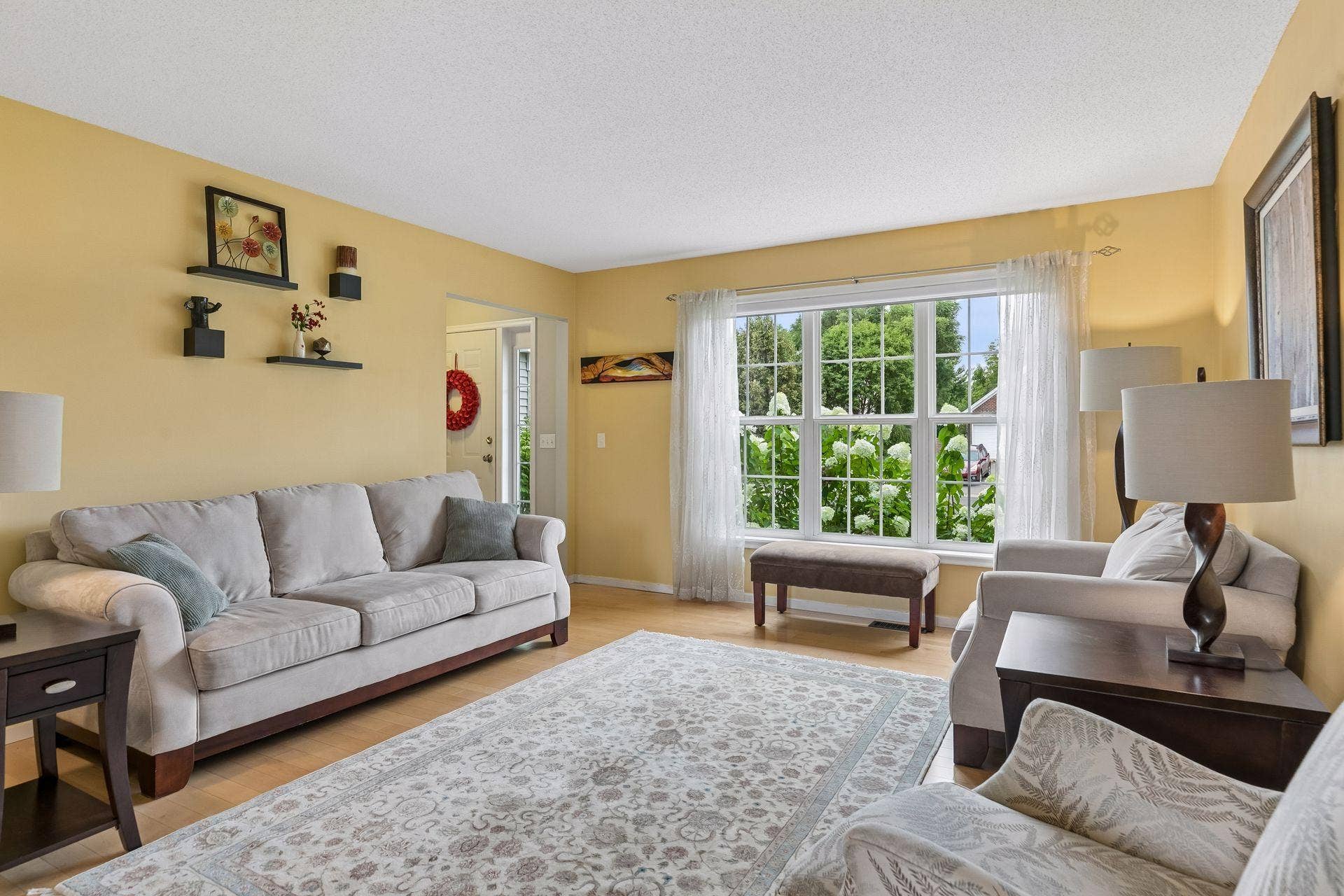 957 Lake Ridge Bay, Woodbury, MN 55129 Natural light pours through a large picture window, complementing the spacious layout and creating an inviting setting for entertaining or relaxing.