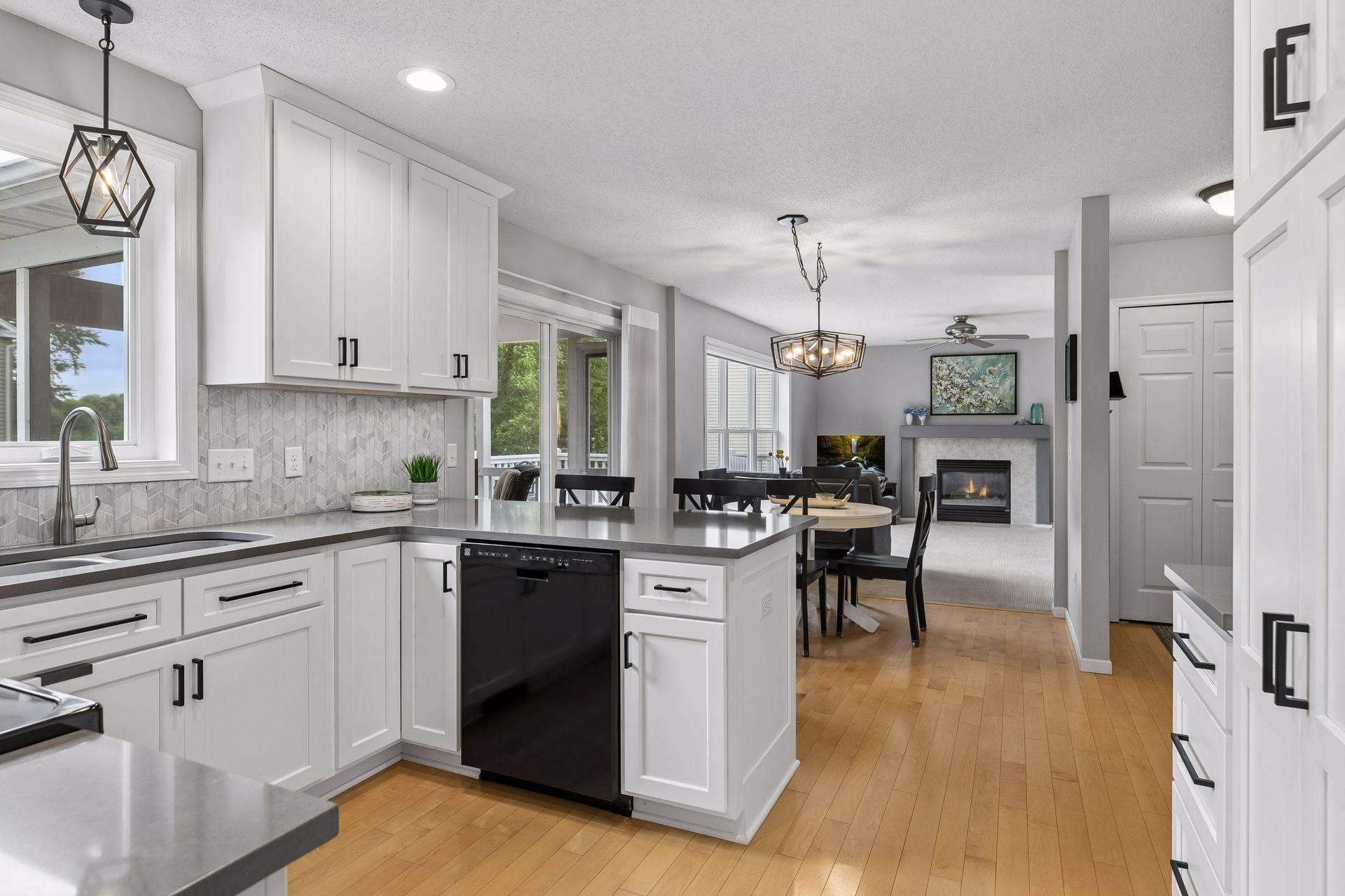 957 Lake Ridge Bay, Woodbury, MN 55129 An open layout connects the kitchen to the informal dining space and family room beyond, creating a cohesive setting for everyday living and entertaining.