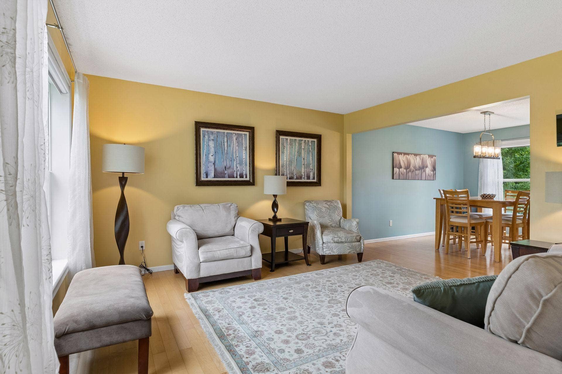 957 Lake Ridge Bay, Woodbury, MN 55129 The maple hardwood flooring extends through the living room, creating a seamless connection to the adjacent formal dining room.