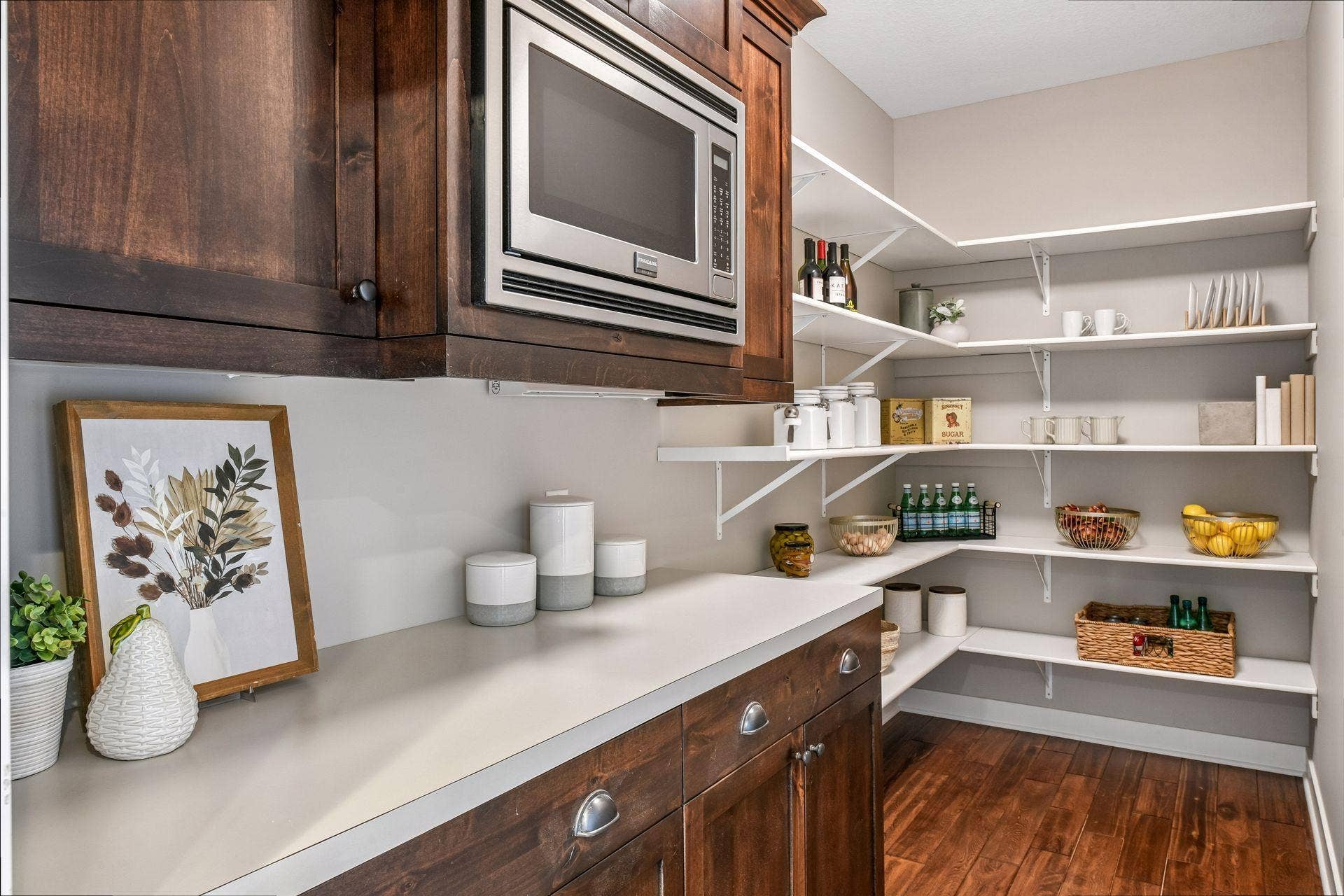 2444 Woods Drive, Victoria, MN 55386 Generous walk-in pantry with additional cabinetry, countertop workspace, and conveniently-located microwave.