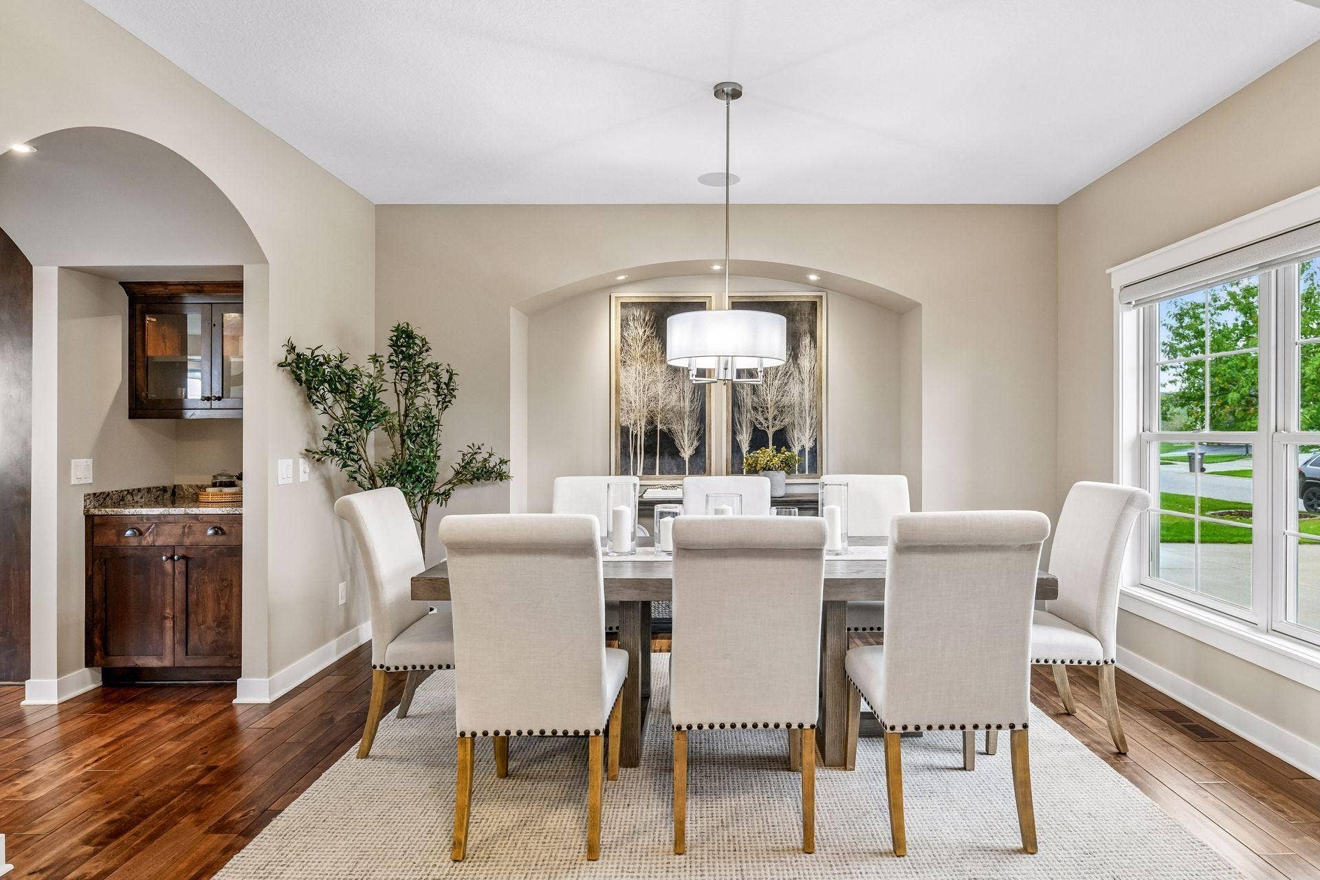 2444 Woods Drive, Victoria, MN 55386 Spacious dining room framed by graceful arched architectural details and warm hardwood floors.