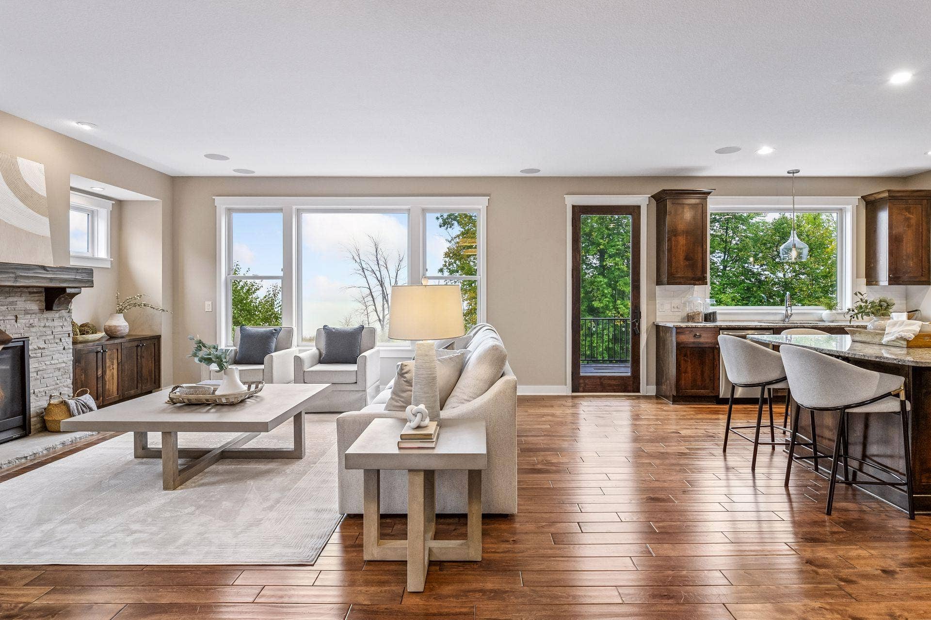 2444 Woods Drive, Victoria, MN 55386 Great room with stunning hardwood floors, oversized windows, and a stone-surround gas fireplace with custom built-ins.