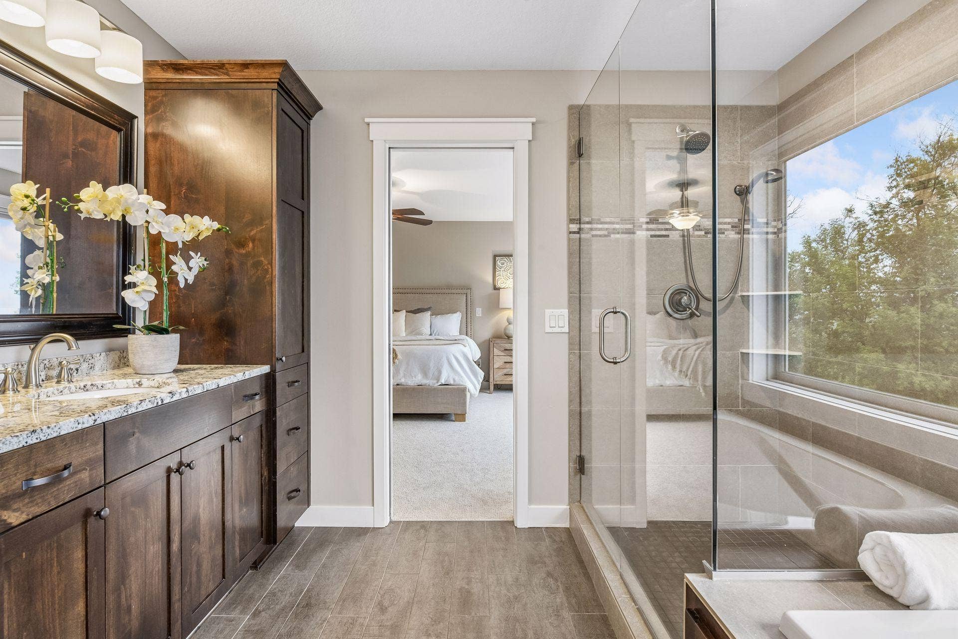2444 Woods Drive, Victoria, MN 55386 Spa-inspired primary bath with soaking tub, glass-enclosed shower, double vanity, and amazing treetop and lake views.