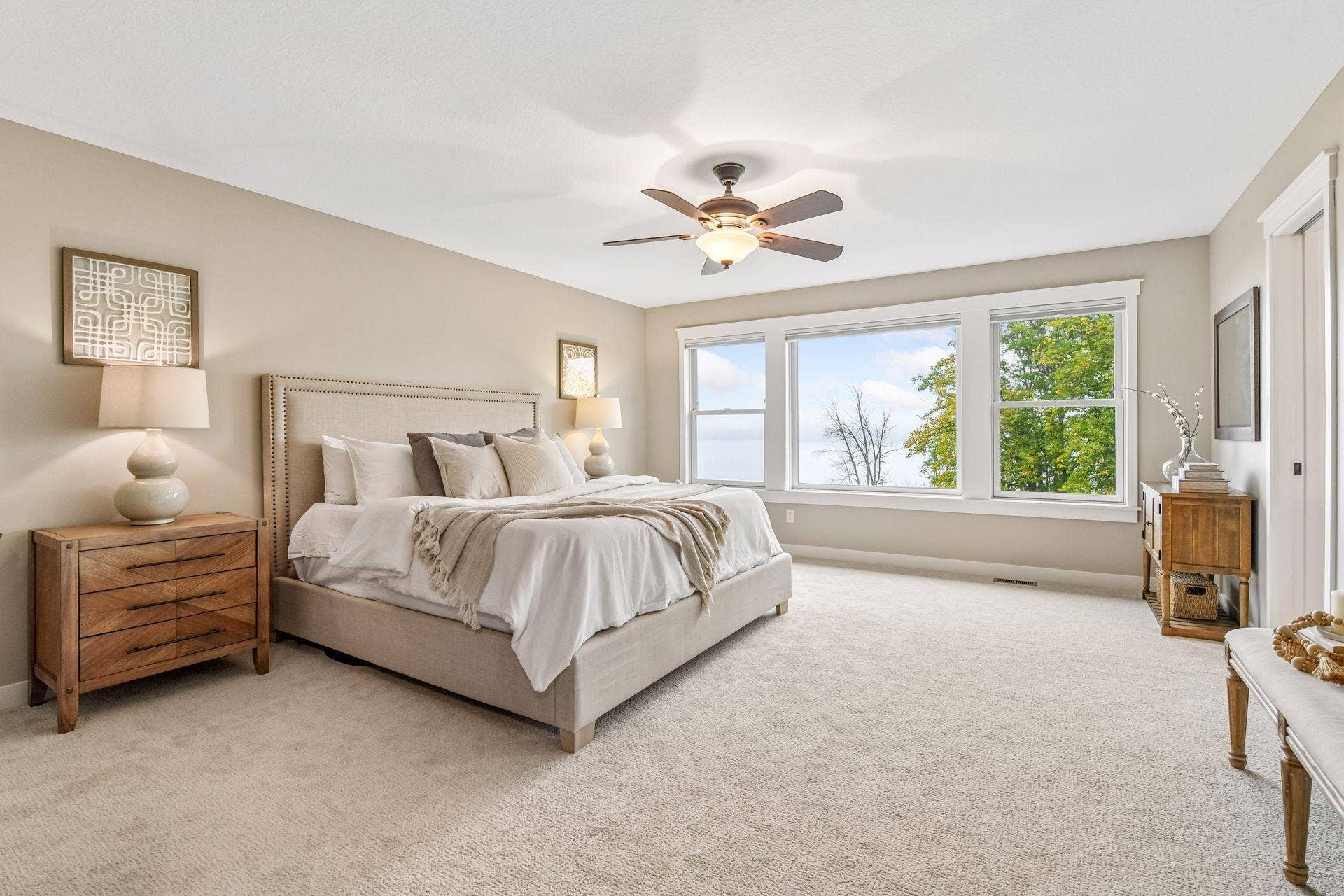 2444 Woods Drive, Victoria, MN 55386 A serene, oversized primary suite features a wall of windows, soft natural light, and plenty of space to create a comfortable private retreat.