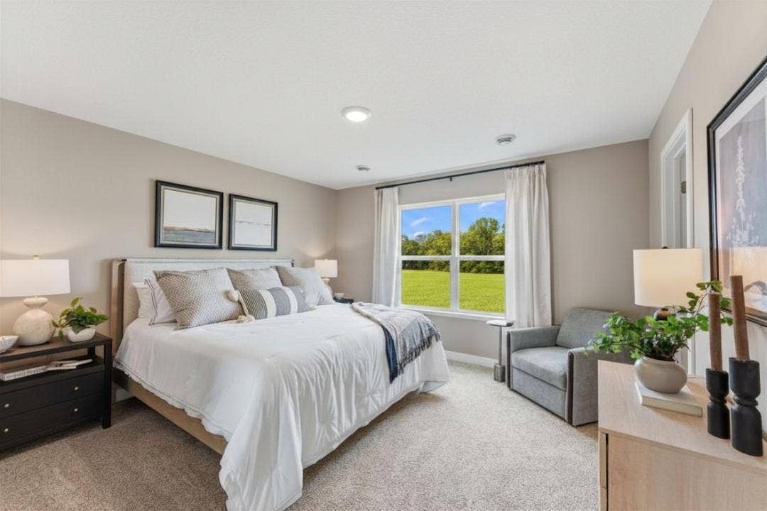 859 Stoneridge Parkway, Dundas, MN 55019 Spacious primary suite with private bath and walk-in closet. Photo of model home. Colors and finishes may vary.
