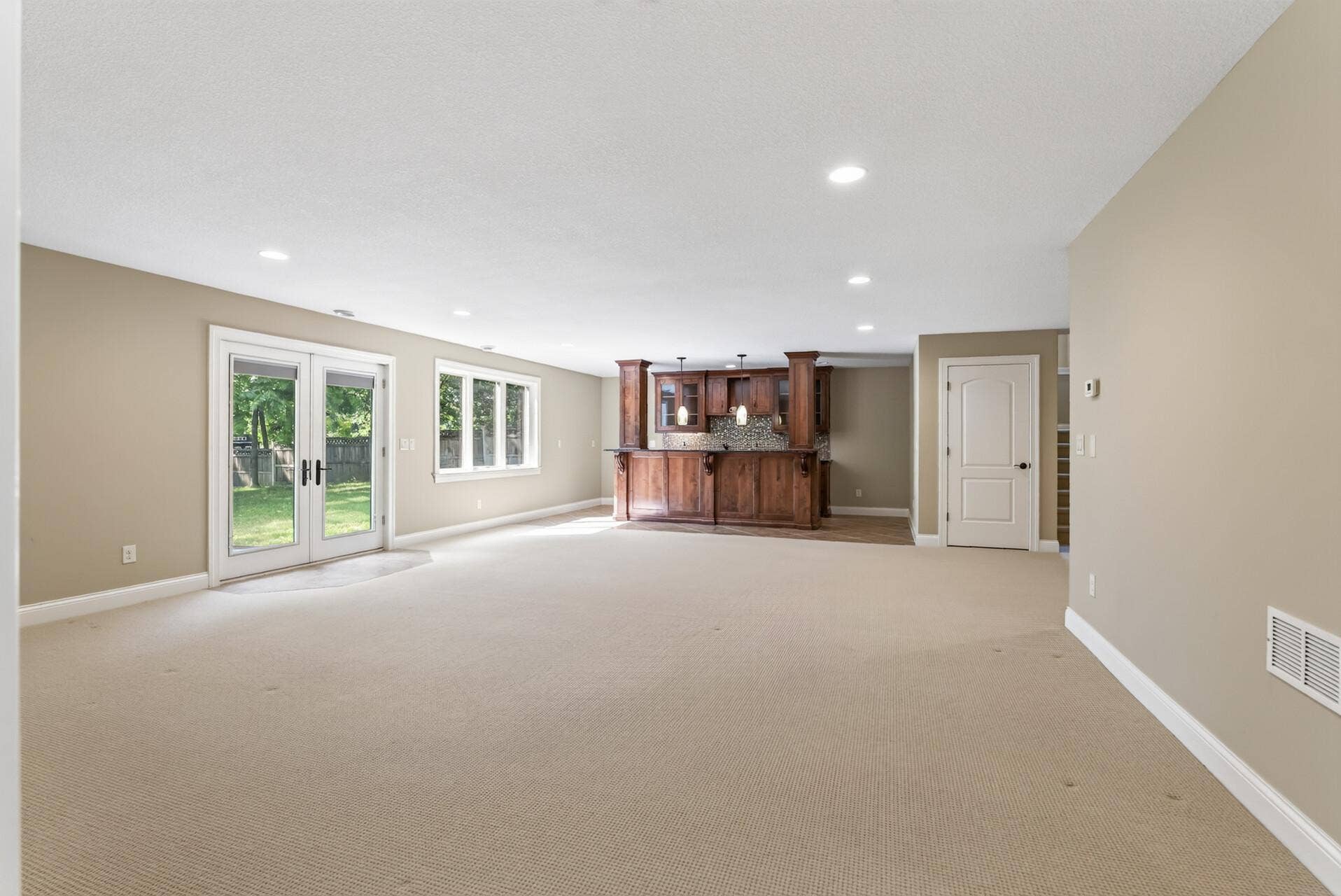 Generous proportions create the perfect setting for movie nights, game days, or evenings spent entertaining around the impressive nearby bar.
