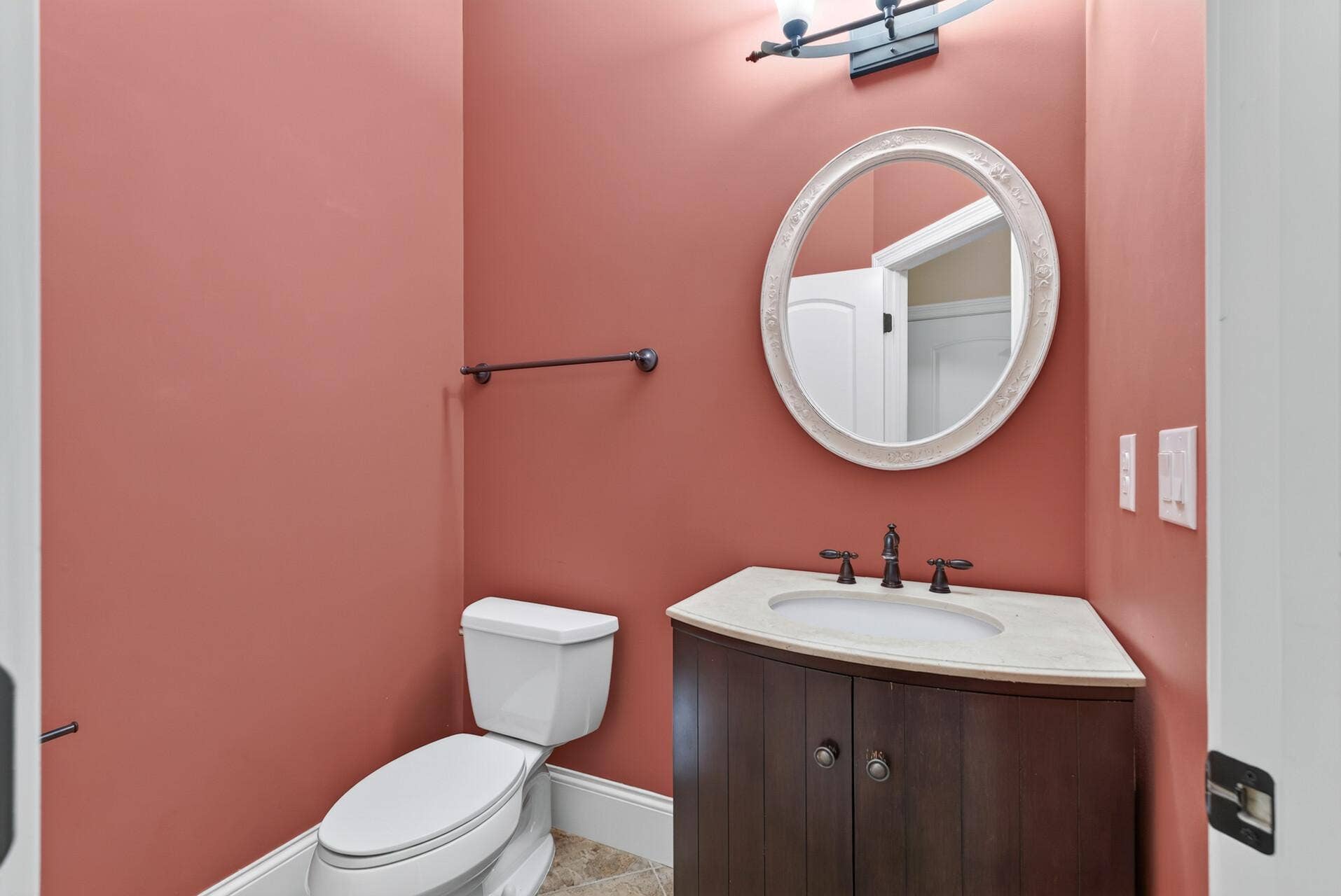 Conveniently located just off the mudroom, the generously sized main-level powder room offers a beautifully finished and welcoming space for guests.