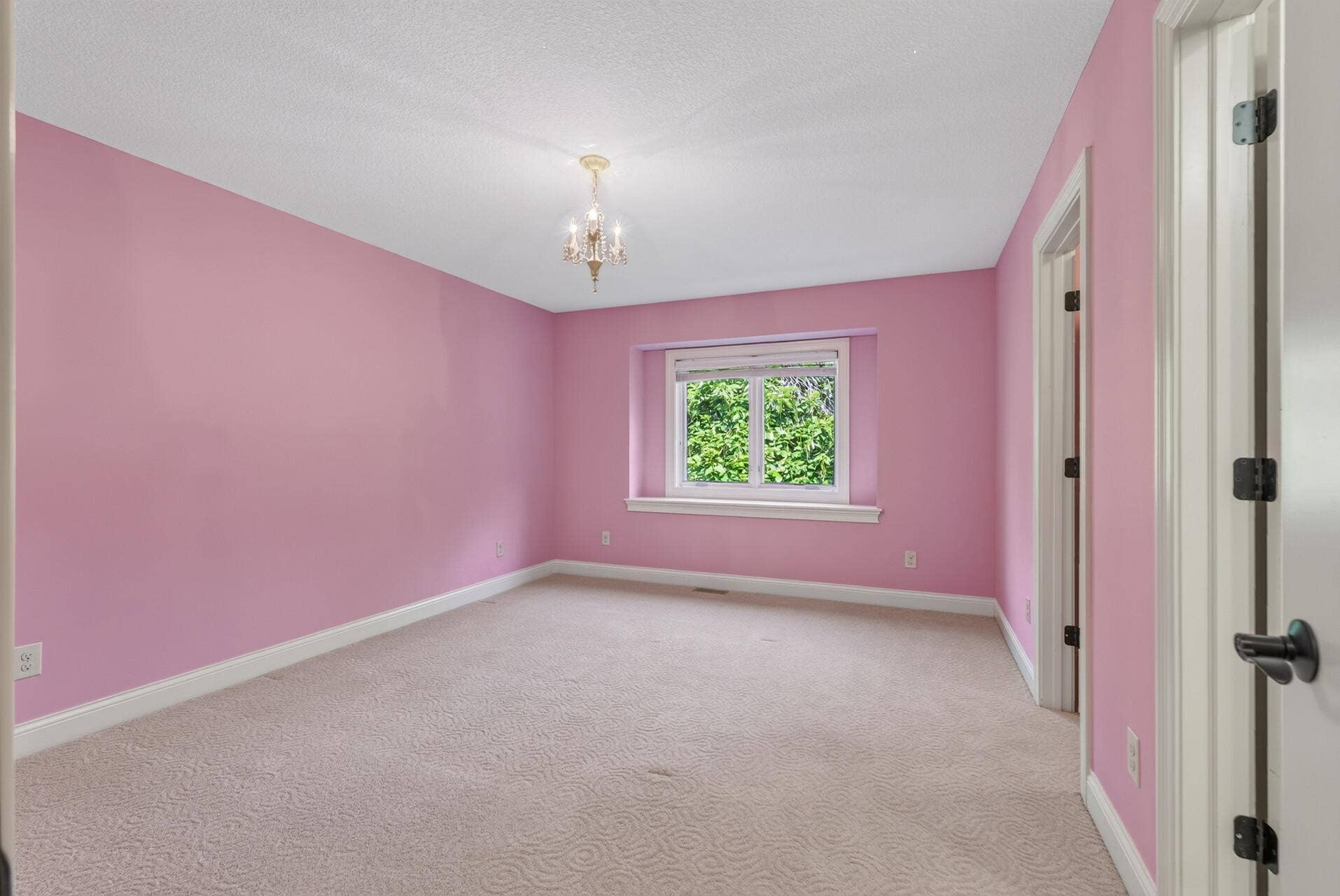 Generously sized and filled with natural light, this upper-level bedroom offers a comfortable and inviting retreat with plenty of room to make it your own.