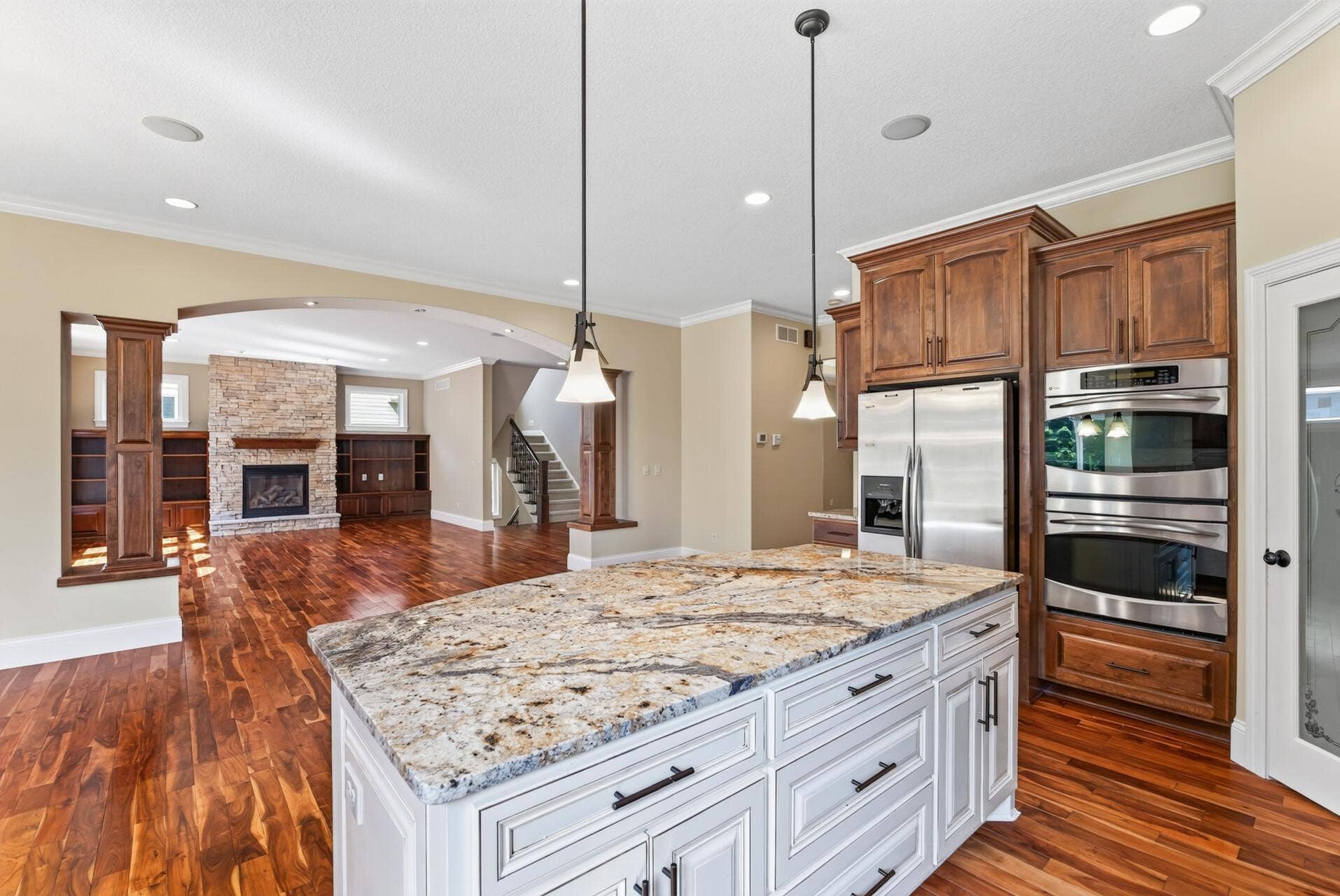 The impressive oversized kitchen island commands attention, offering an abundance of storage, generous workspace, and a natural gathering place at the heart of the home.