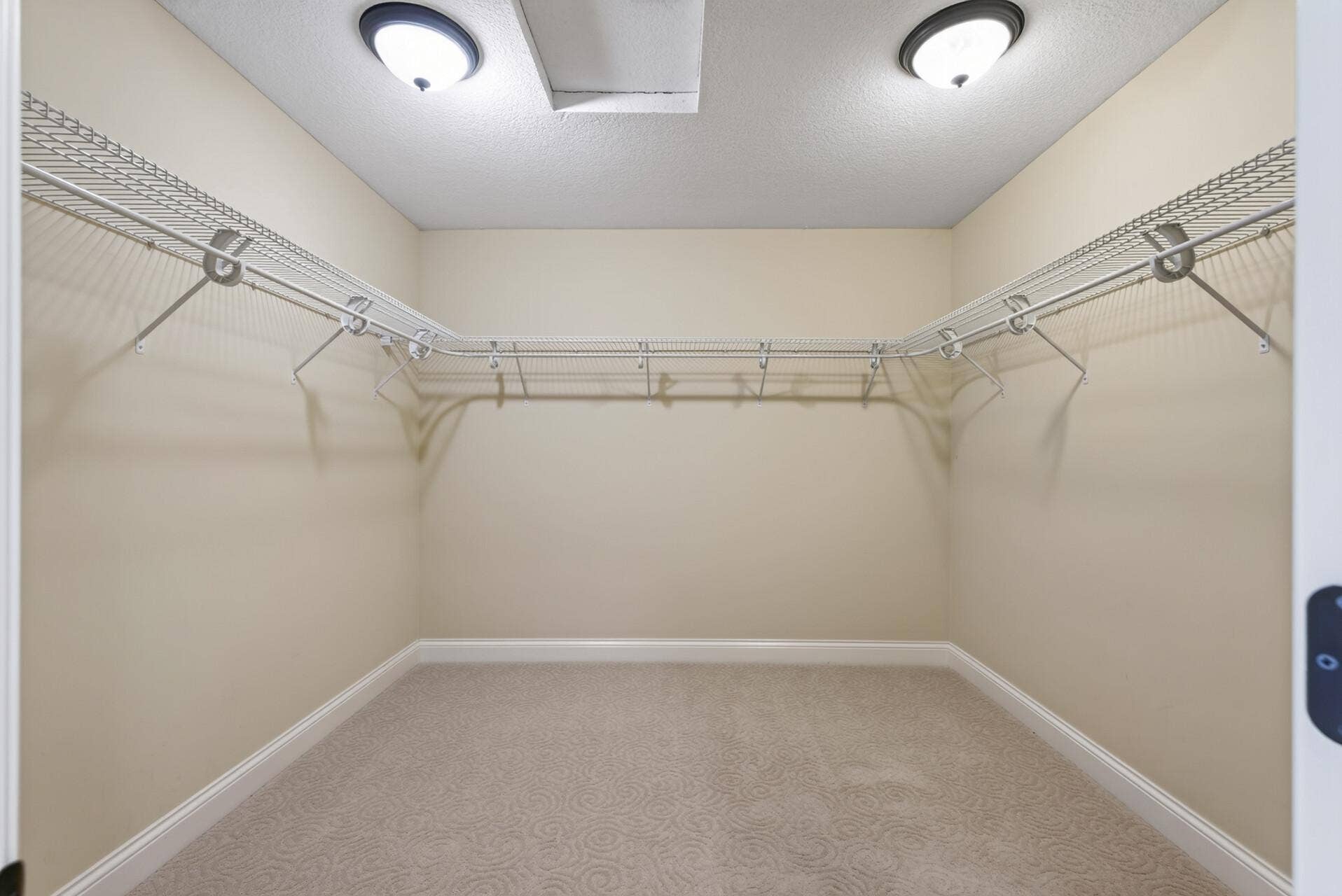 A spacious walk-in closet offers exceptional storage and organization, while a second walk-in closet provides even more roomanother thoughtful luxury within the primary suite.
