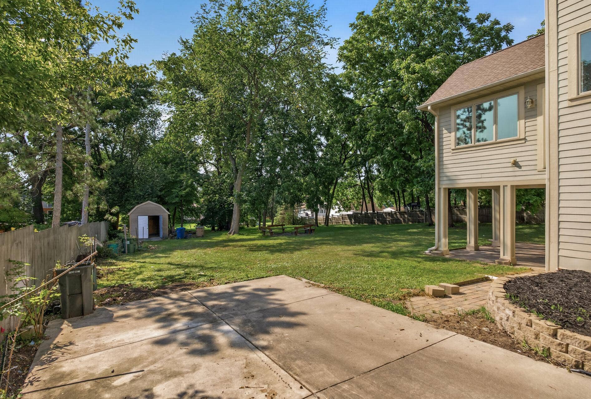 The expansive, flat backyard offers incredible versatility and a beautiful blank canvas for your outdoor vision.
