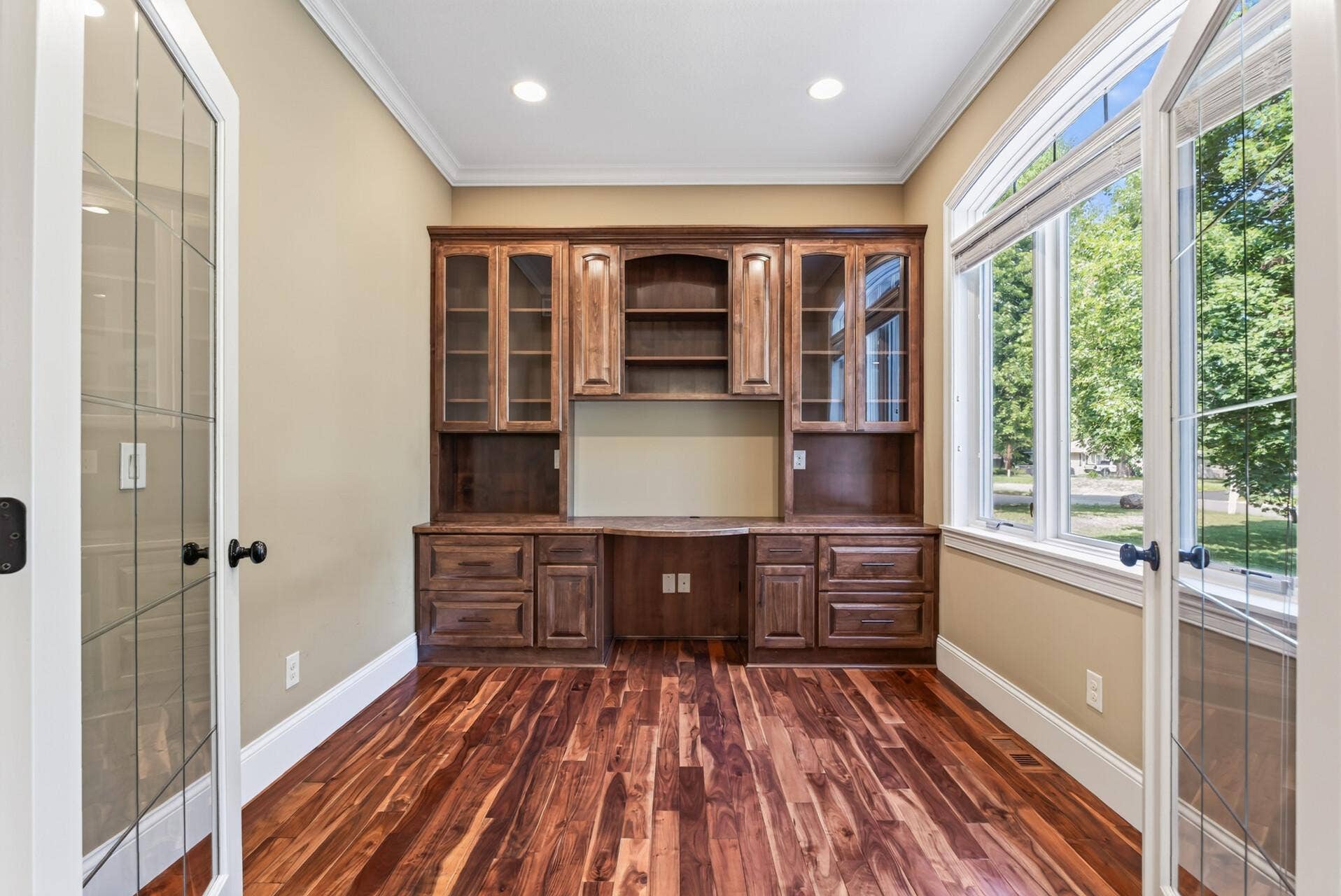 Exceptional built-in cabinetry surrounds the office with both beauty and function, showcasing the level of craftsmanship found throughout the residence.