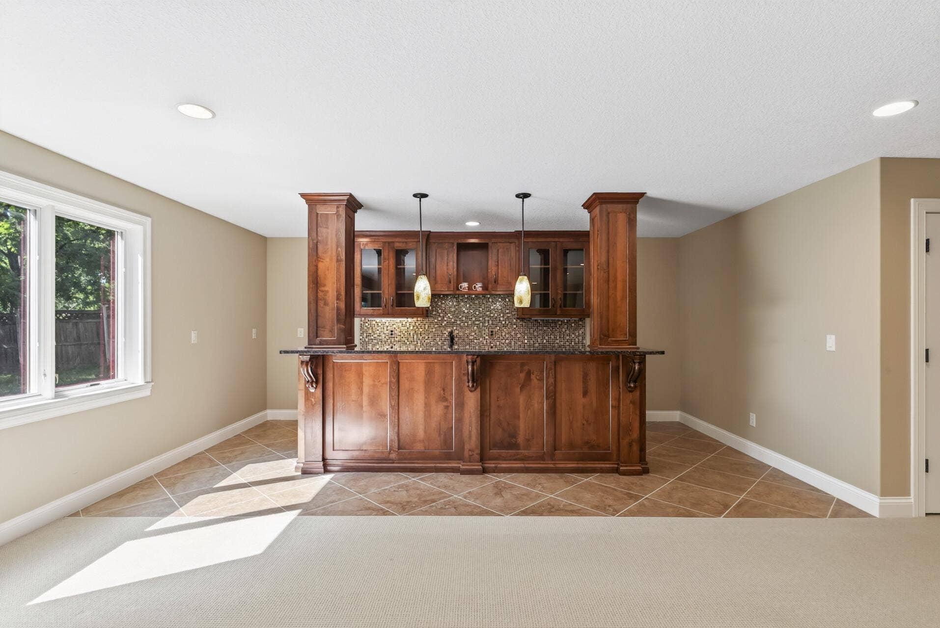 An executive-style bar anchors the walkout lower level, creating a sophisticated destination for entertaining.