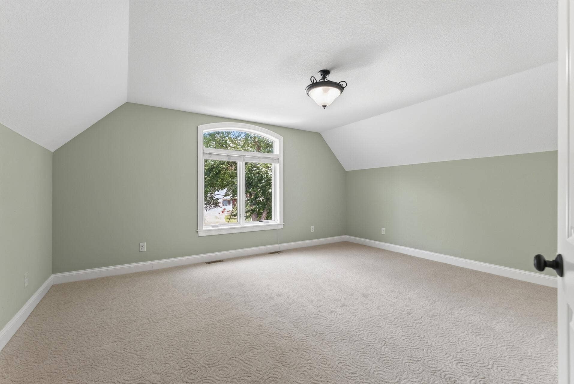Positioned at the front of the home, this exceptionally spacious bedroom feels bright and grand, with raised ceilings adding an impressive sense of height and openness.
