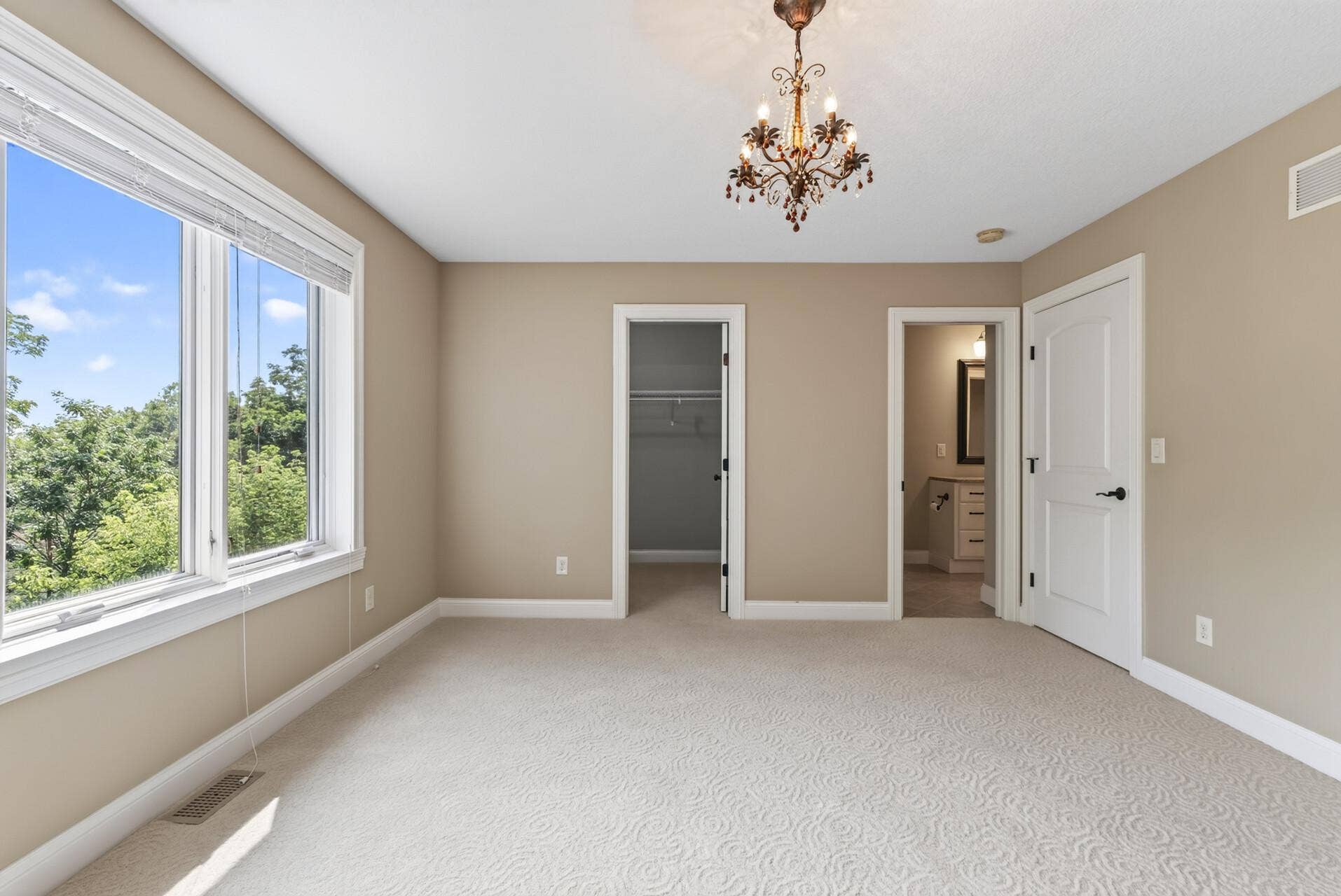 This spacious upper-level bedroom enjoys direct access to one of the homes full bathrooms, adding an extra level of privacy and convenience.