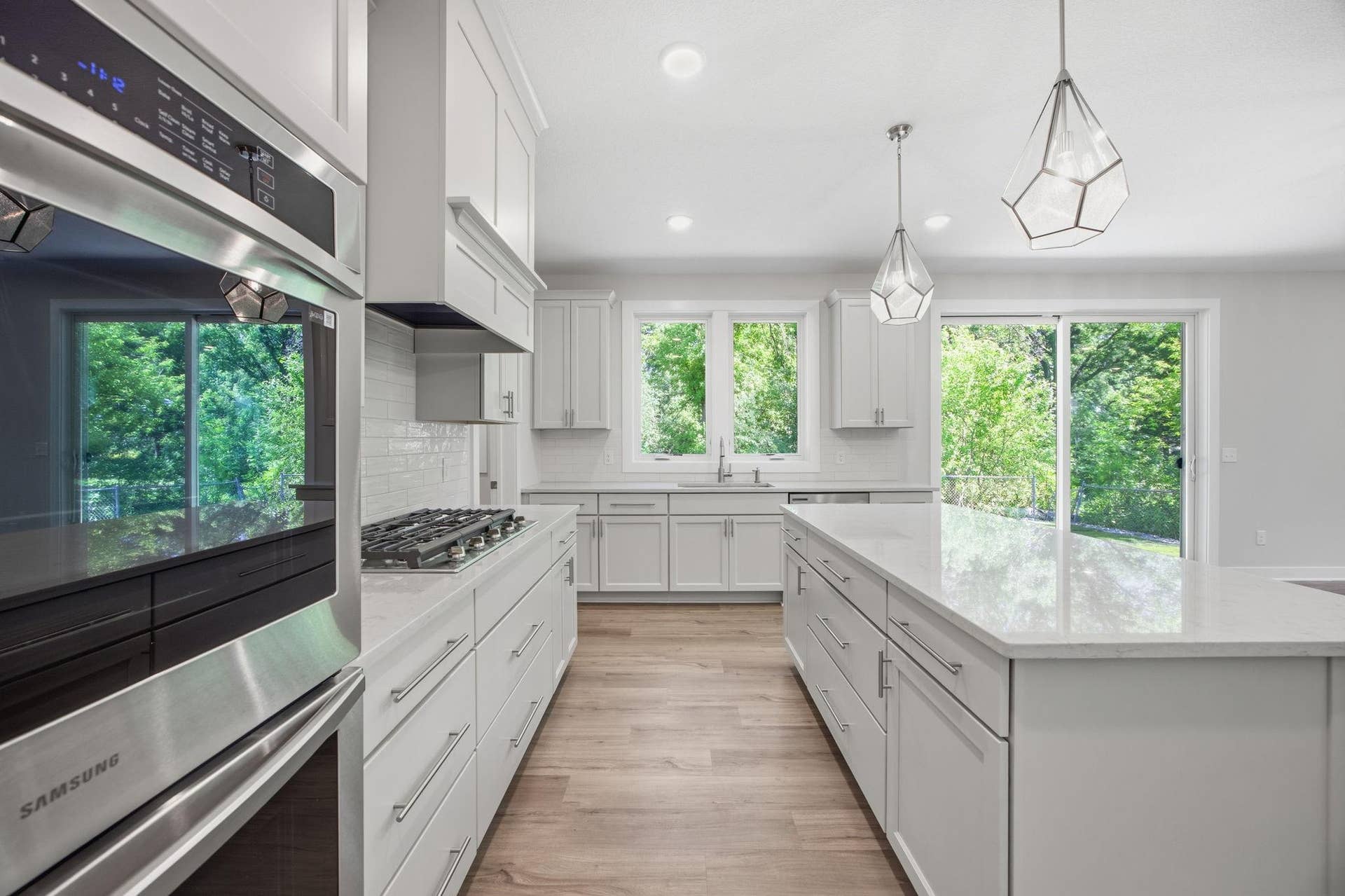 2399 Laurie Court W, Roseville, MN 55113 A closer look at the gourmet kitchen, featuring quartz countertops, a center island with abundant storage and shelving, stainless steel appliances, and exceptional design for both everyday living and entertaining.