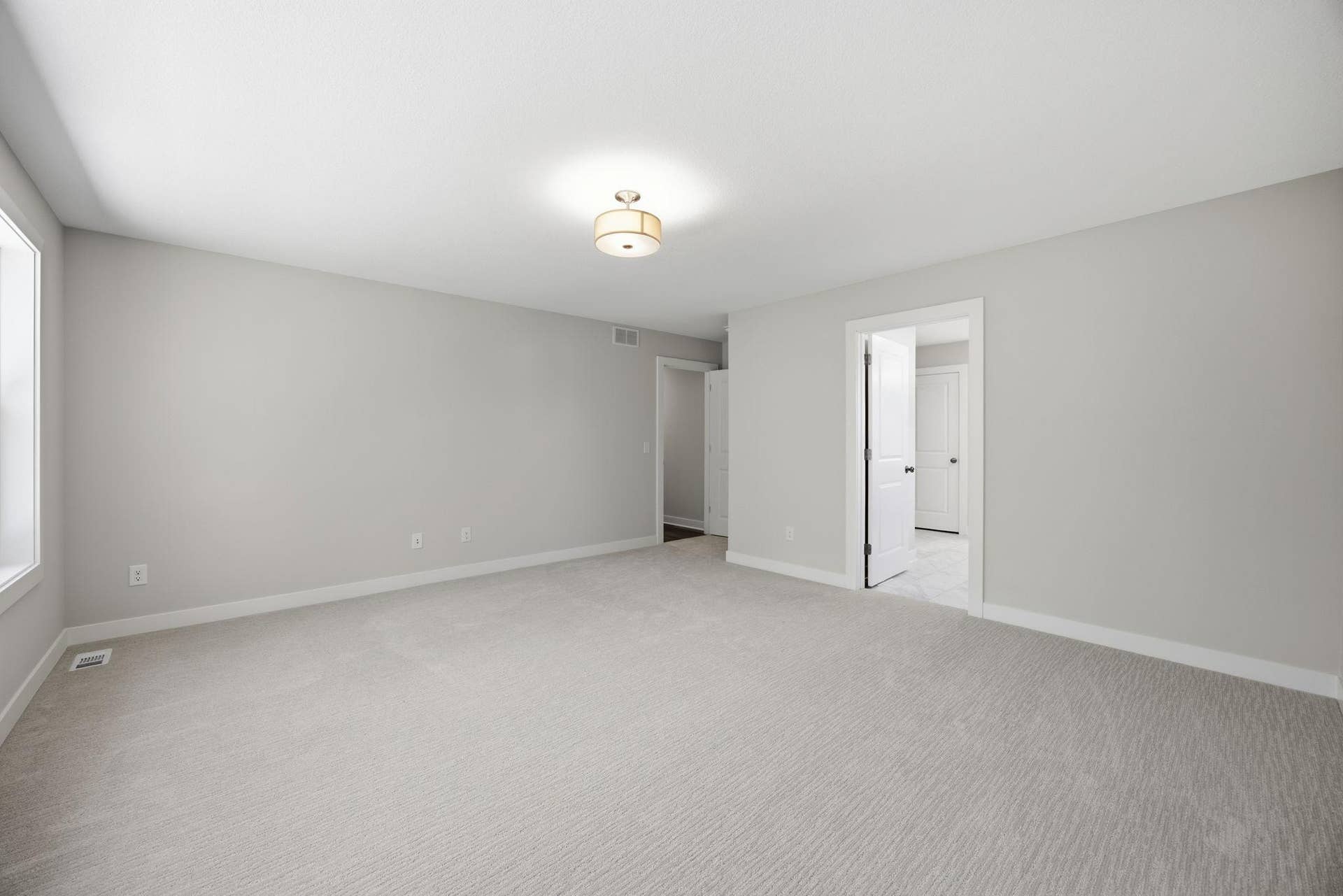 2399 Laurie Court W, Roseville, MN 55113 Unfurnished primary bedroom with direct access to the luxurious primary bath, creating a private and relaxing retreat.