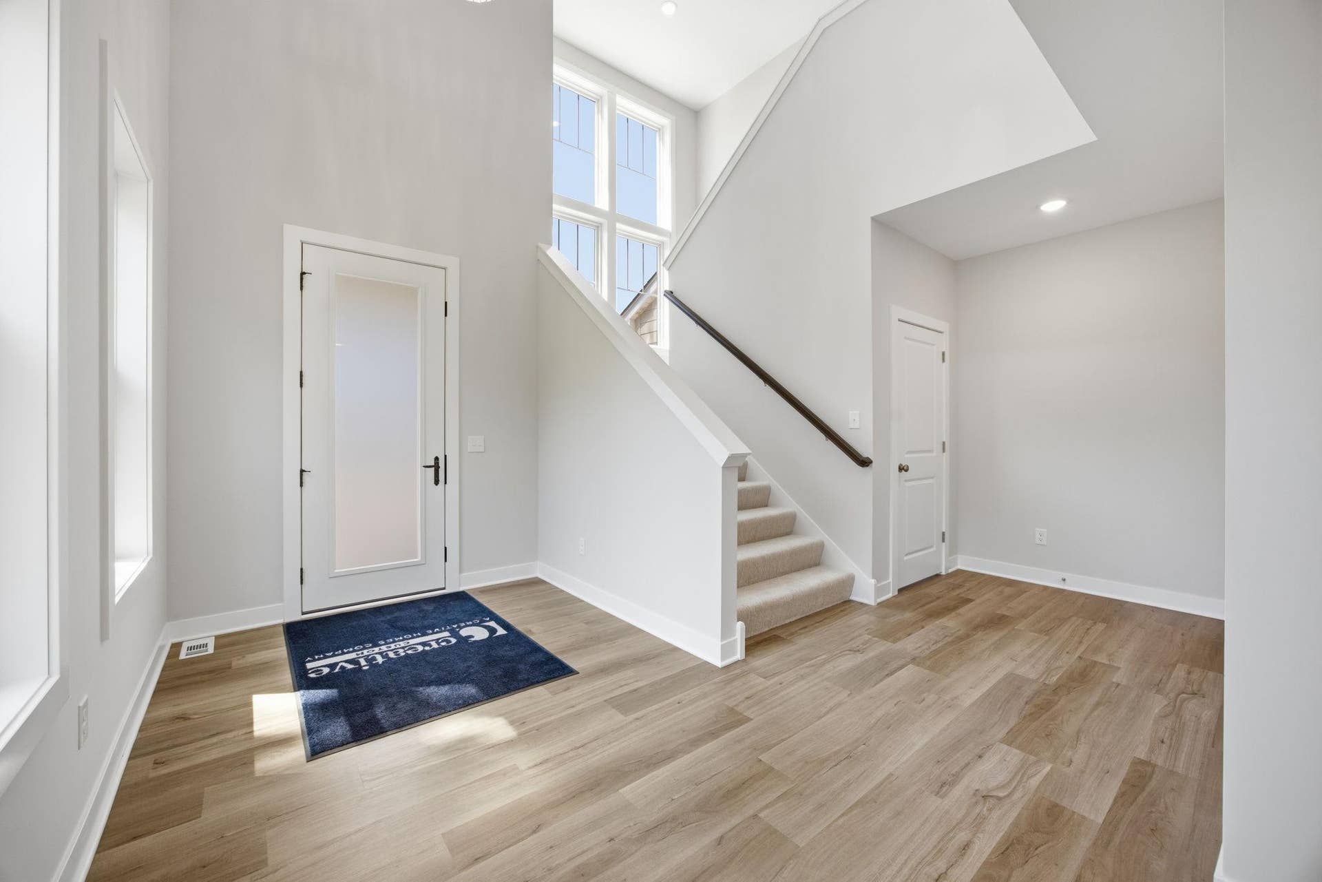 2399 Laurie Court W, Roseville, MN 55113 Unfurnished view of the impressive two-story foyer, featuring soaring ceilings and expansive windows.