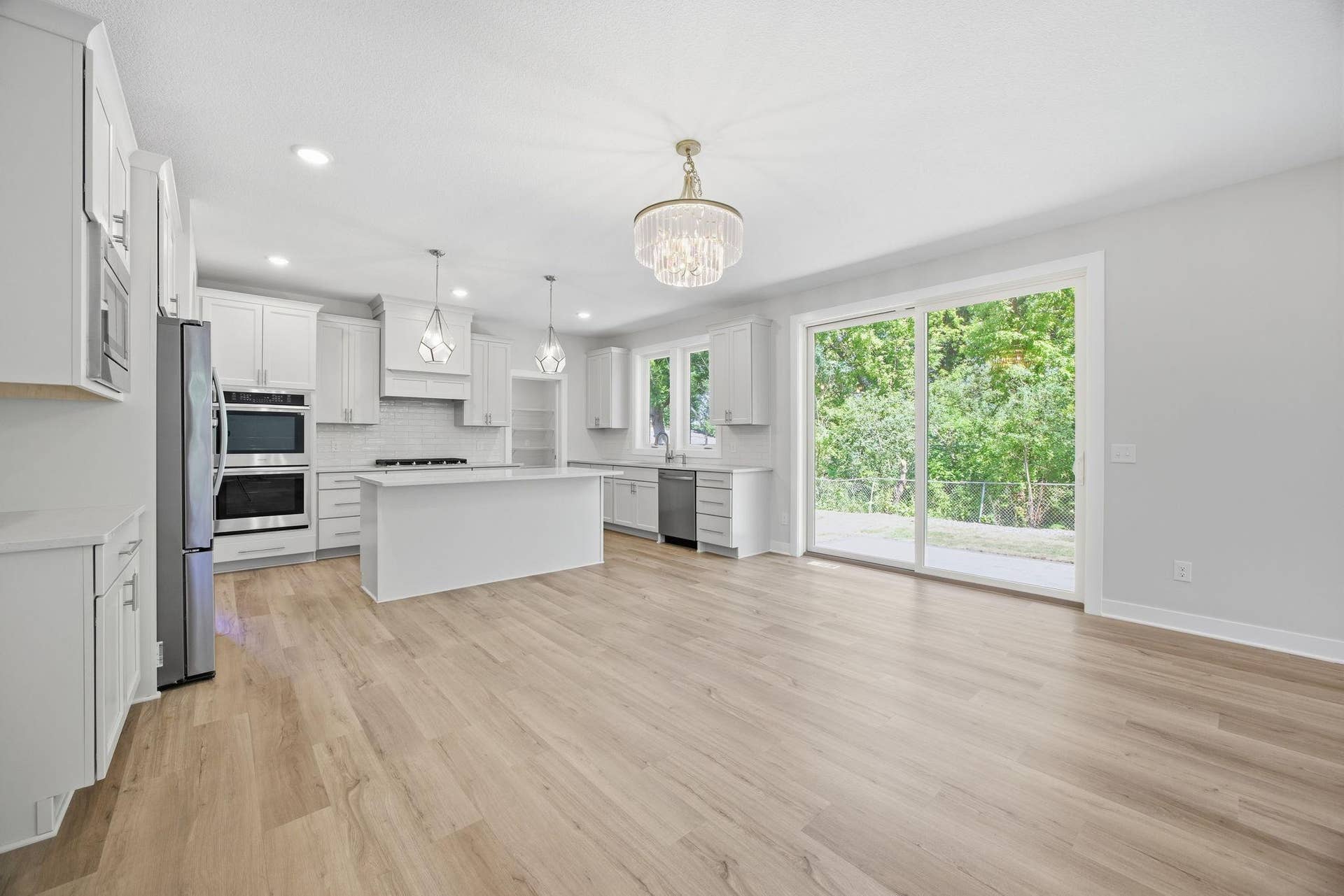 2399 Laurie Court W, Roseville, MN 55113 The gourmet kitchen is featuring quartz countertops, a center island with a breakfast bar, a porcelain tile backsplash, stainless steel appliances, and an extraordinary 15' x 6' walk-in pantry.