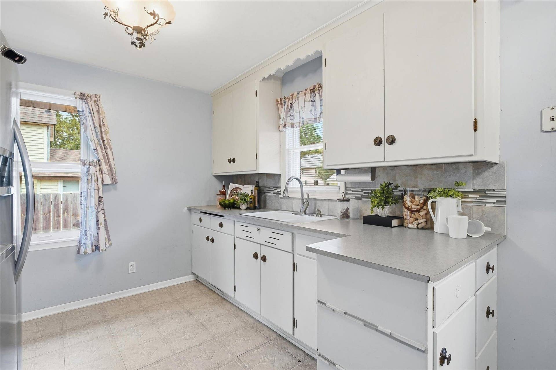 4840 N 6th Street, 41, Minneapolis, MN 55430 Kitchen features abundant cabinetry, generous counter space, and a decorative tile backsplash with accent detailing.