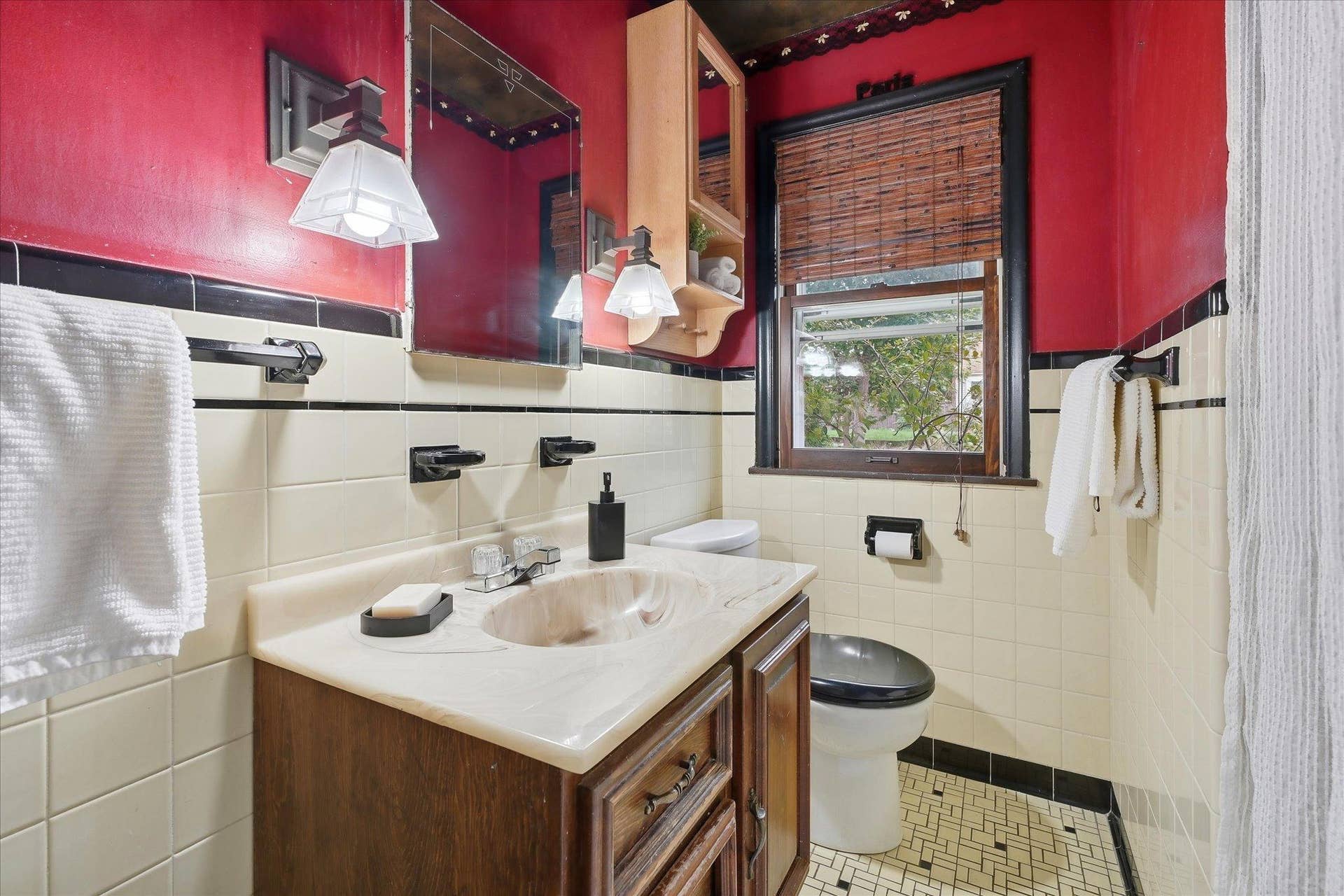 4840 N 6th Street, 41, Minneapolis, MN 55430 Main-level bathroom features classic tile walls with contrasting black accents, and a vanity with storage.