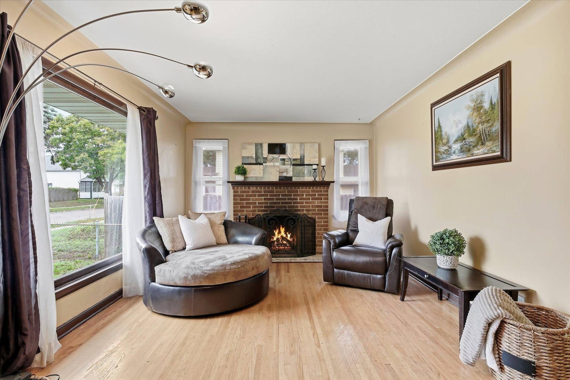 4840 N 6th Street, 41, Minneapolis, MN 55430 Inviting living room centers around the brick wood-burning fireplace, flanked by windows and complemented by beautiful hardwood flooring.