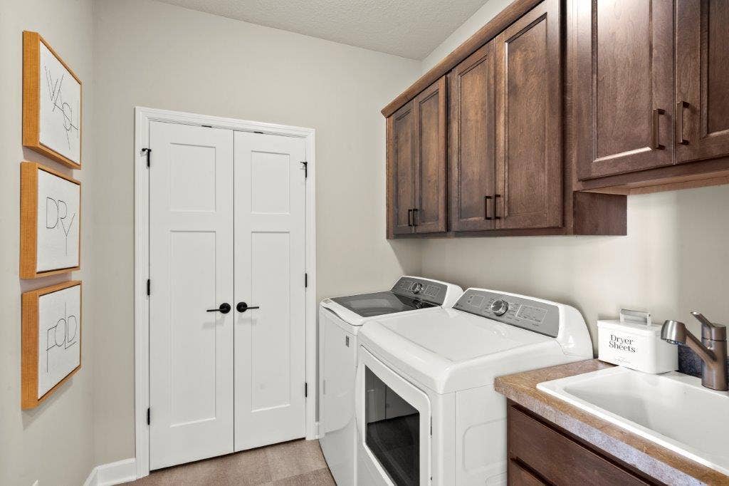 Mudroom with storage, storage, a practical utility sink, and durable and beautiful LVT floor. Love it!