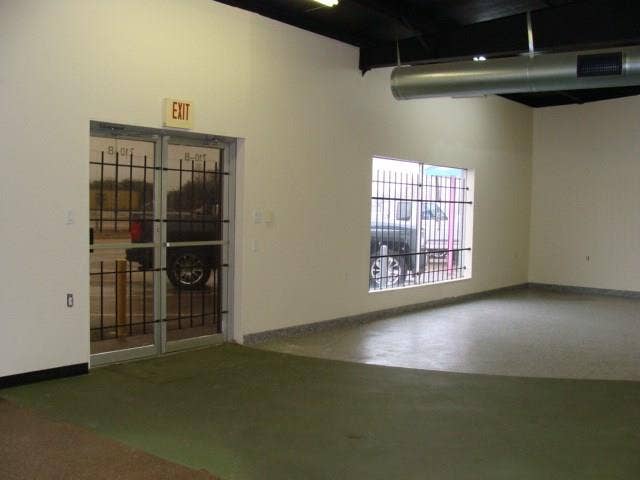 Enter into open area with one office.  Concrete painted flooring.