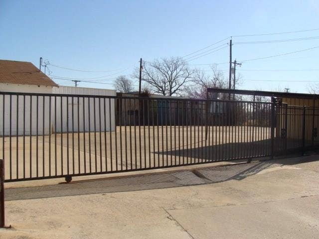 Back fenced in area for additional parking.