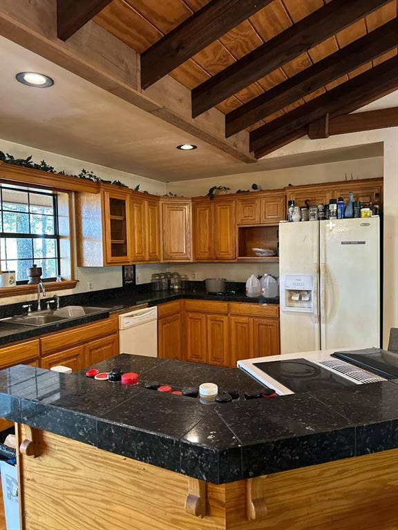 11420 County Road 420, Tyler, TX 75704 Kitchen featuring vaulted ceiling with beams, sink, white appliances, a kitchen island, and a kitchen breakfast bar