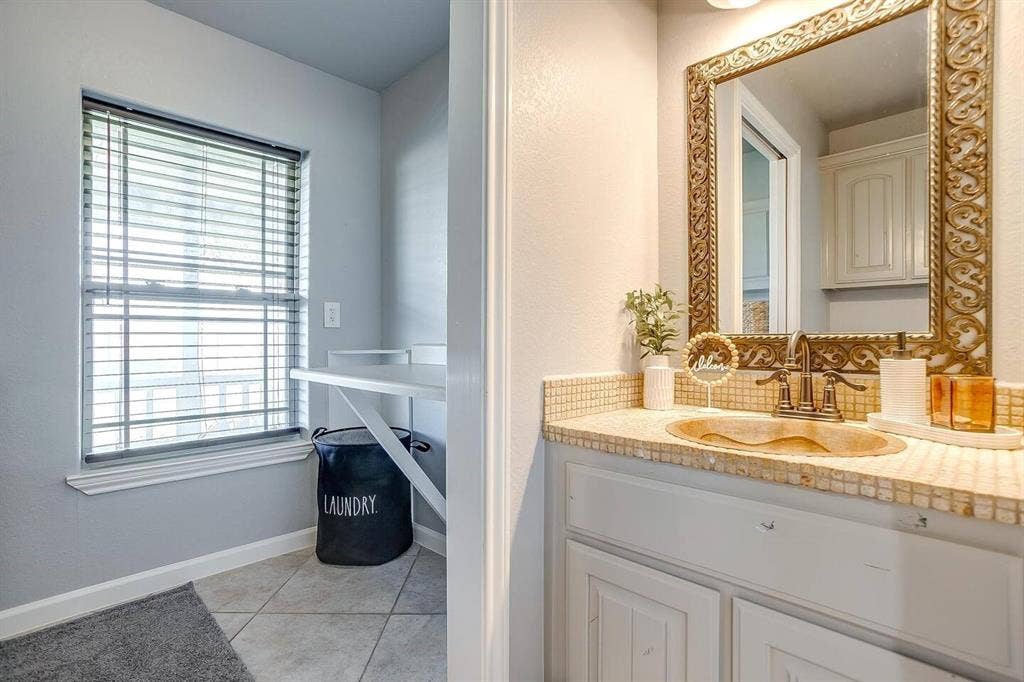 12001 Fm 2331, Godley, TX 76044 Bathroom featuring vanity, tile patterned flooring, and backsplash