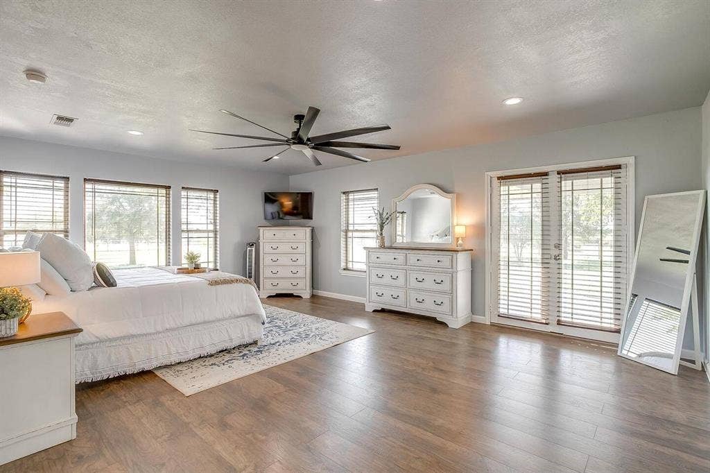 12001 Fm 2331, Godley, TX 76044 Bedroom with dark wood-type flooring, access to outside, a textured ceiling, and ceiling fan