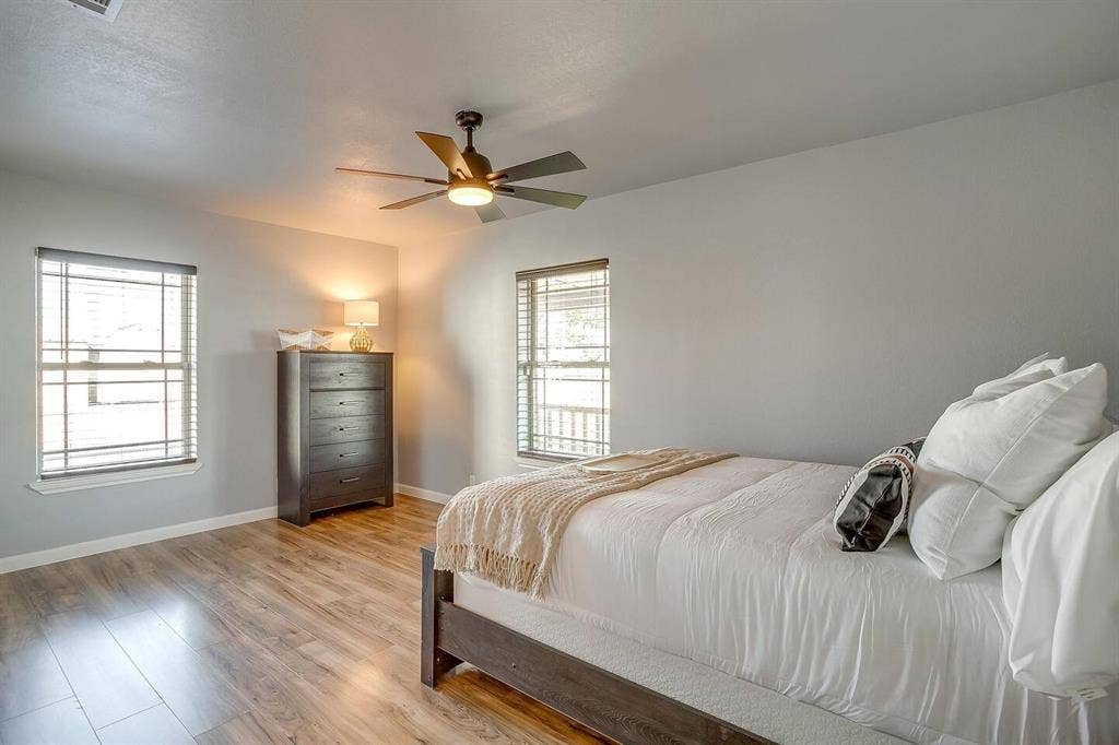12001 Fm 2331, Godley, TX 76044 Bedroom with light hardwood / wood-style floors, multiple windows, and ceiling fan