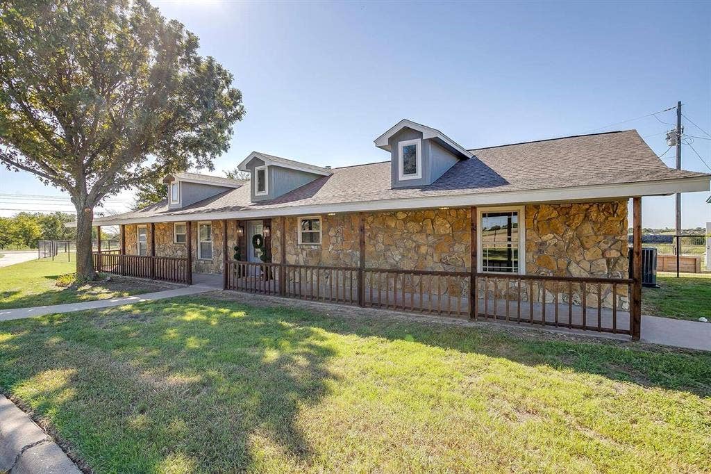12001 Fm 2331, Godley, TX 76044 Country-style home featuring central AC unit, a porch, and a front lawn