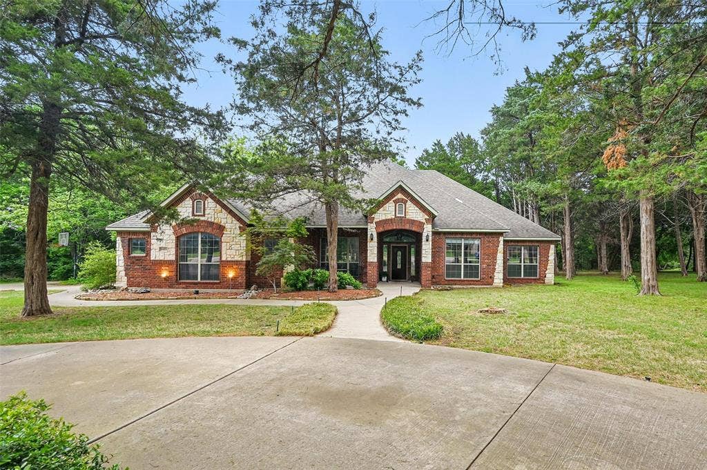 3421 Mindy Lane, Midlothian, TX 76065 Craftsman inspired home with brick siding, roof with shingles, and a front yard