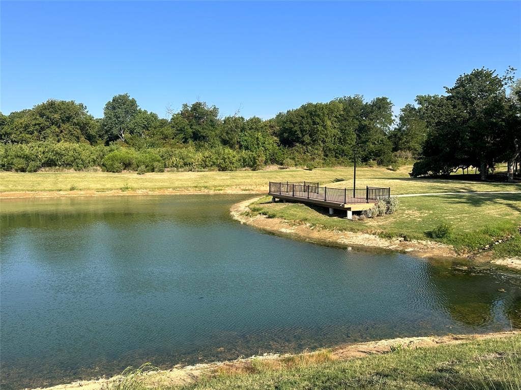 128 Park Avenue, Keller, TX 76262 Expansive pond with a built-in wooden deck and metal railing