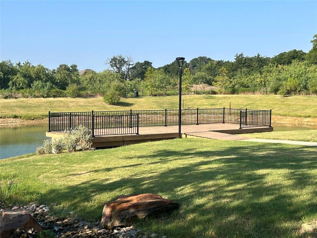 300 Park Avenue, Keller, TX 76262 Waterside deck with black metal railing and natural landscaping