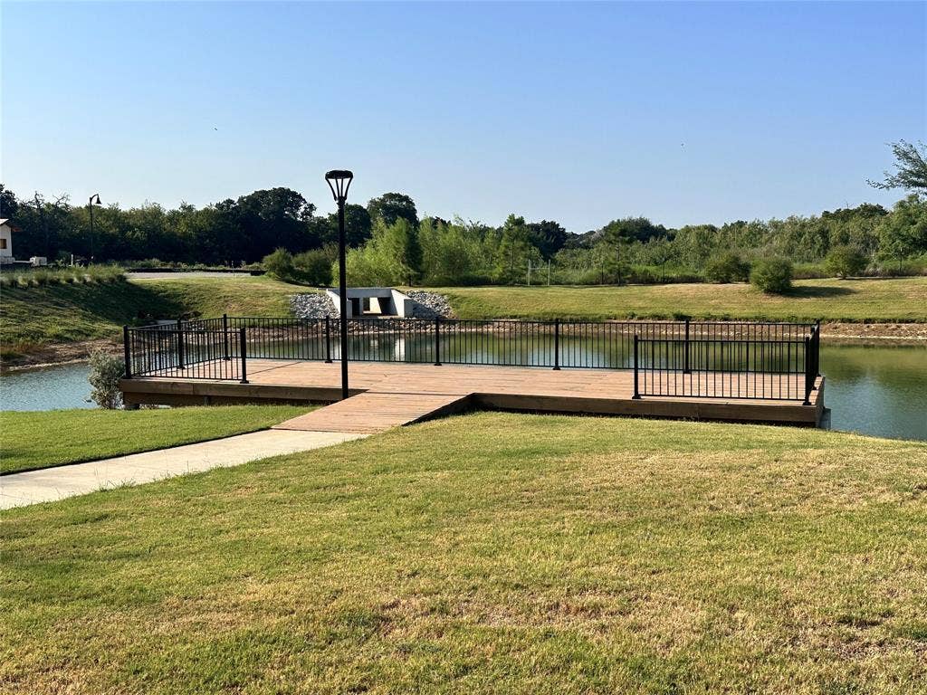 300 Park Avenue, Keller, TX 76262 Waterside deck with black metal railing and natural landscaping