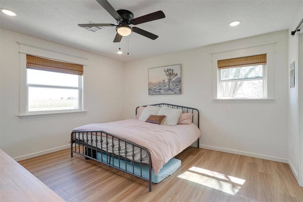 939 Twin Bends Road, Crawford, TX 76638 Bedroom with recessed lighting, baseboards, and wood finished floors