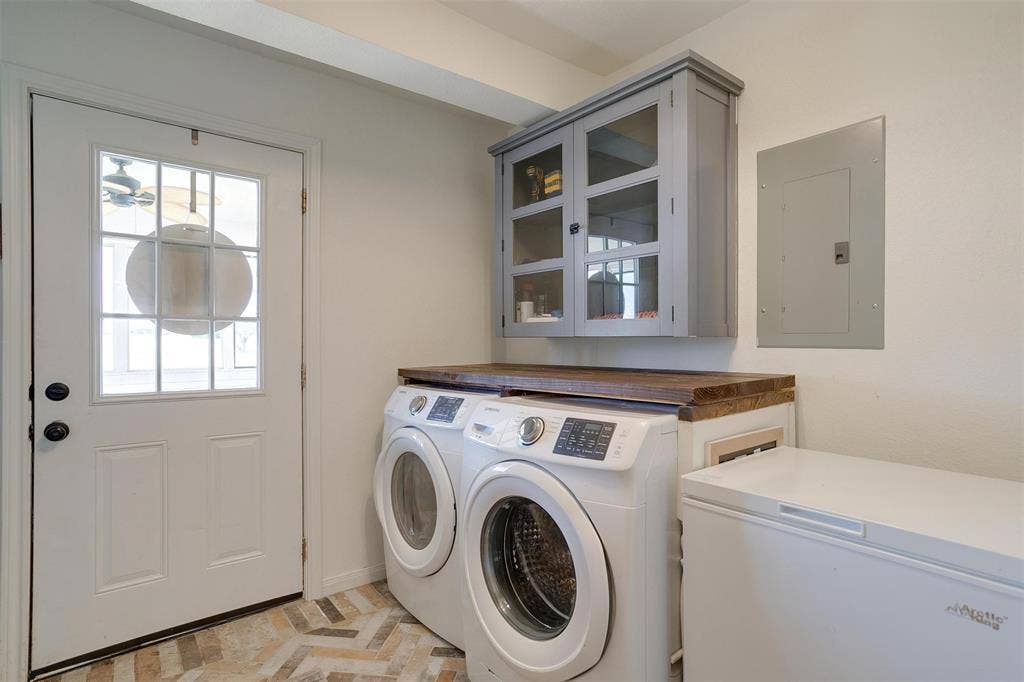 939 Twin Bends Road, Crawford, TX 76638 Washroom featuring electric panel, cabinet space, and washer and dryer