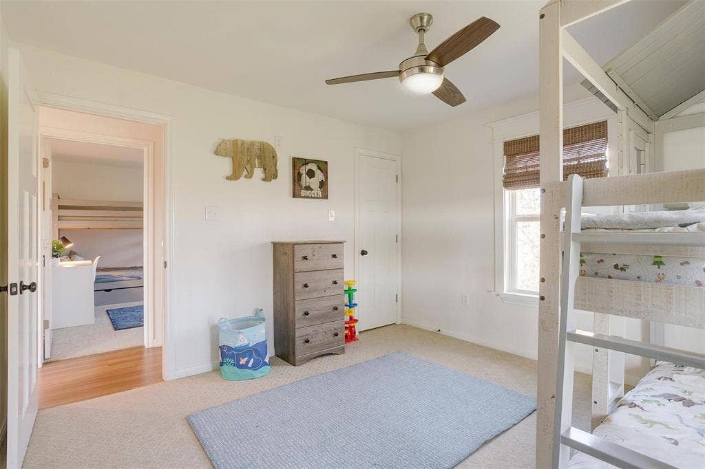 939 Twin Bends Road, Crawford, TX 76638 Carpeted bedroom featuring baseboards and ceiling fan