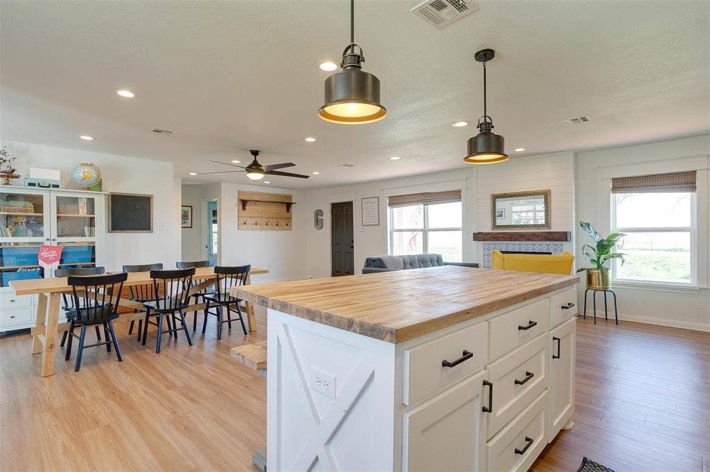 939 Twin Bends Road, Crawford, TX 76638 Kitchen with butcher block countertops, visible vents, white cabinets, and light wood finished floors