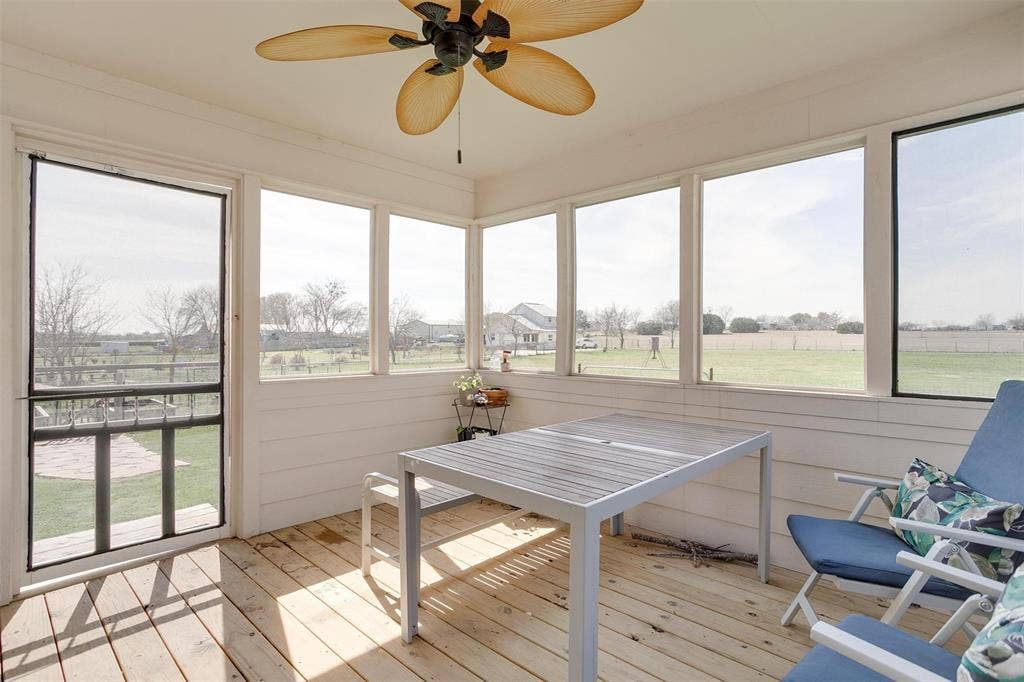 939 Twin Bends Road, Crawford, TX 76638 Sunroom / solarium featuring a rural view, a ceiling fan, and a healthy amount of sunlight