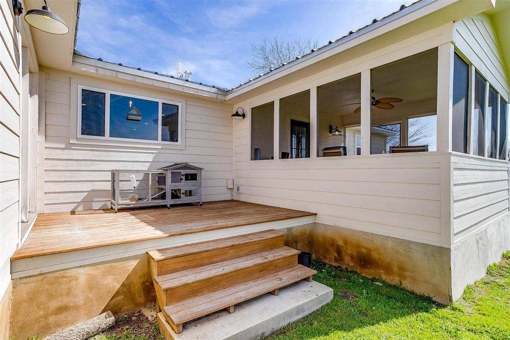 939 Twin Bends Road, Crawford, TX 76638 Wooden deck with a sunroom