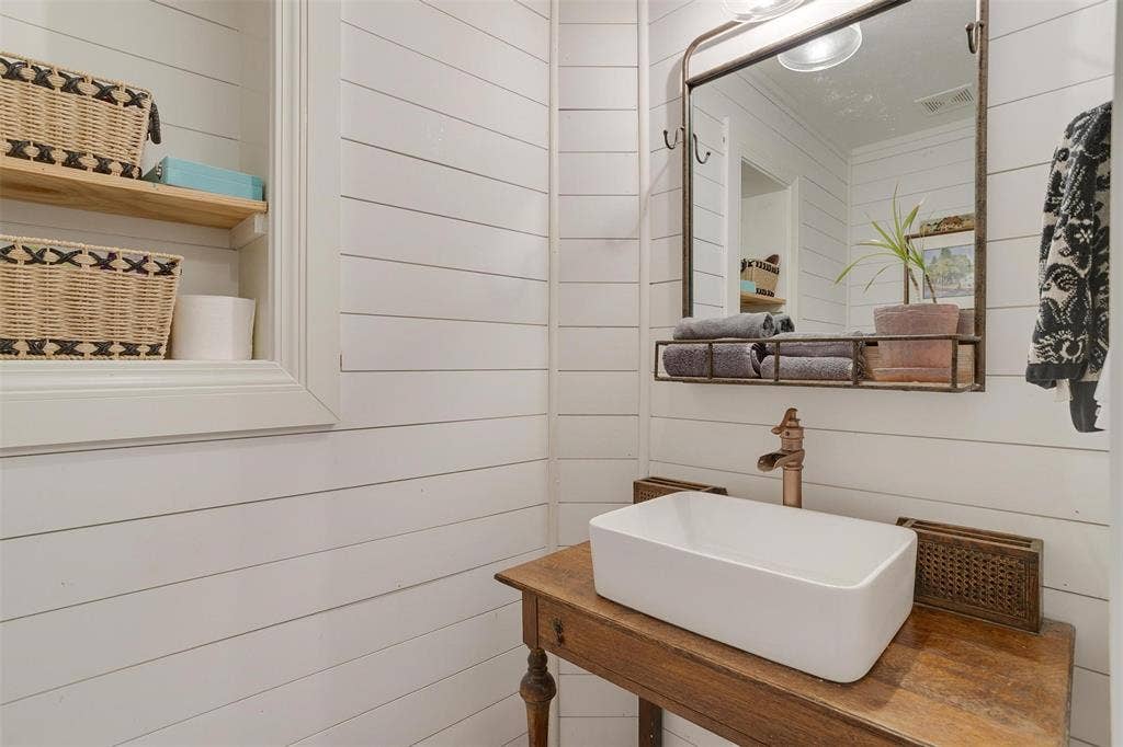 939 Twin Bends Road, Crawford, TX 76638 Bathroom with wooden walls and a sink
