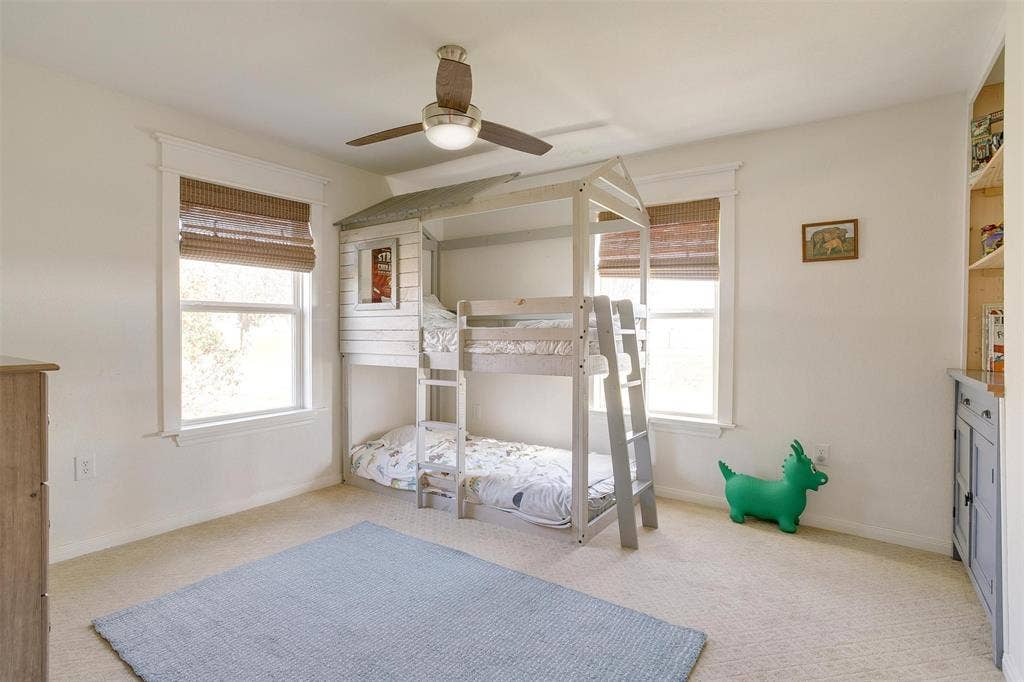 939 Twin Bends Road, Crawford, TX 76638 Bedroom with baseboards, light colored carpet, and ceiling fan