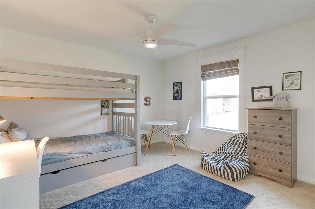 939 Twin Bends Road, Crawford, TX 76638 Carpeted bedroom featuring a ceiling fan and baseboards