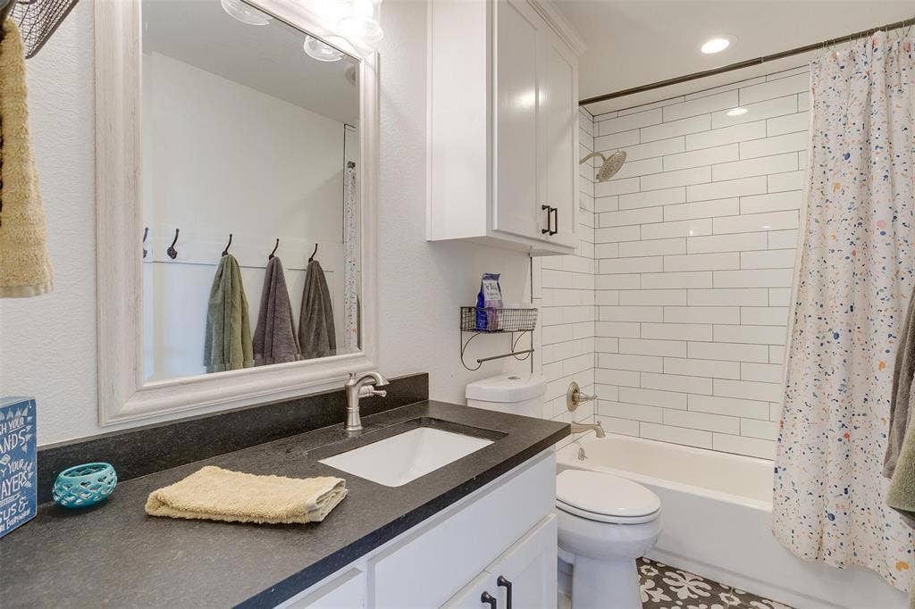 939 Twin Bends Road, Crawford, TX 76638 Bathroom with shower / bath combination with curtain, toilet, and vanity